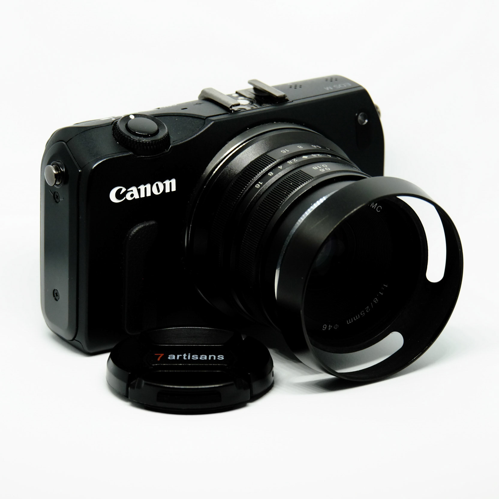 Cheap used Canon EOS M camera, $190 with bag and the 18-55mm kit lens and the small flash. In this shoot, kitted with a 7artisans 25mm manual lens for about $75, new.