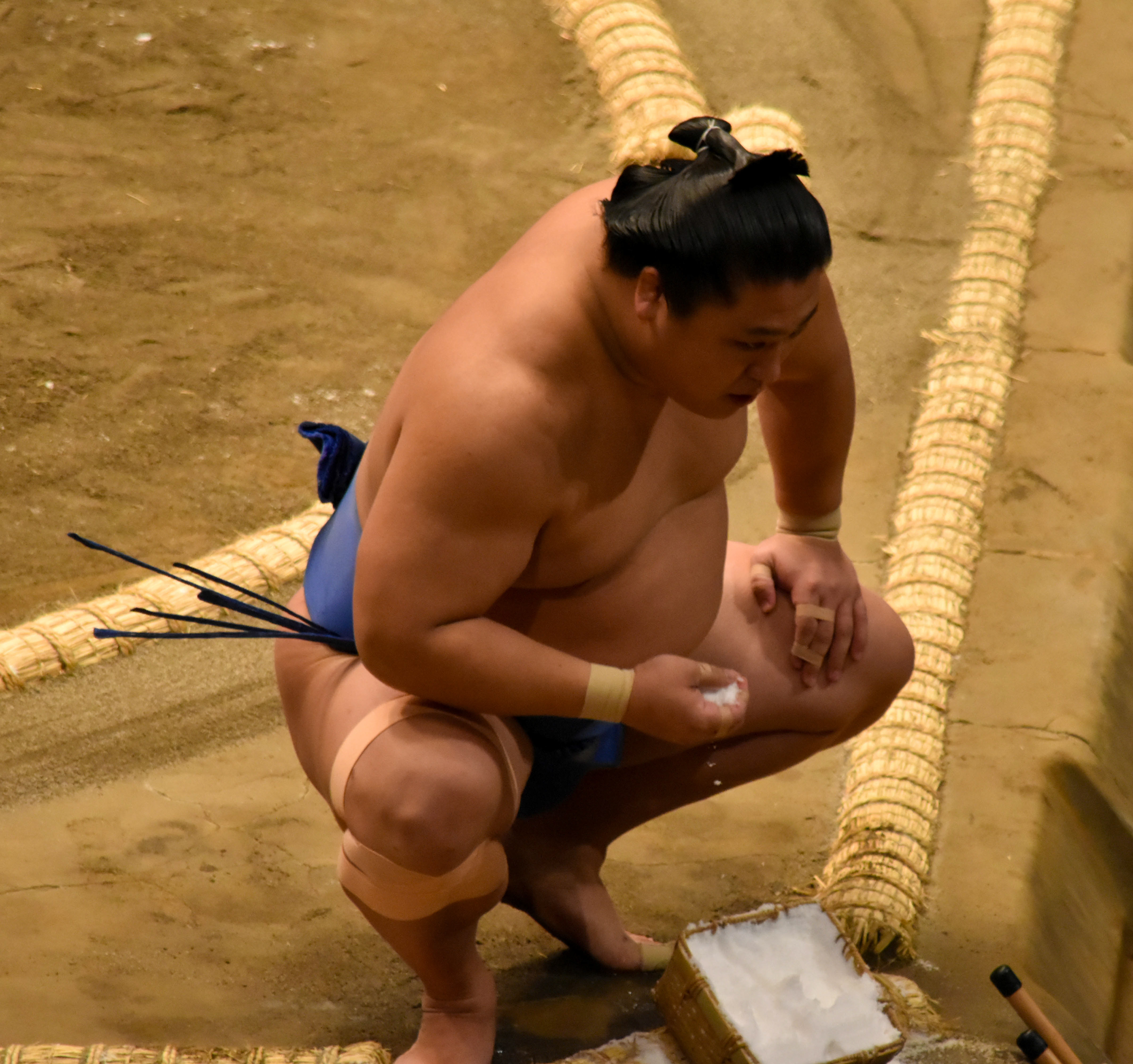 A wrestler getting the salt to purify the ring
