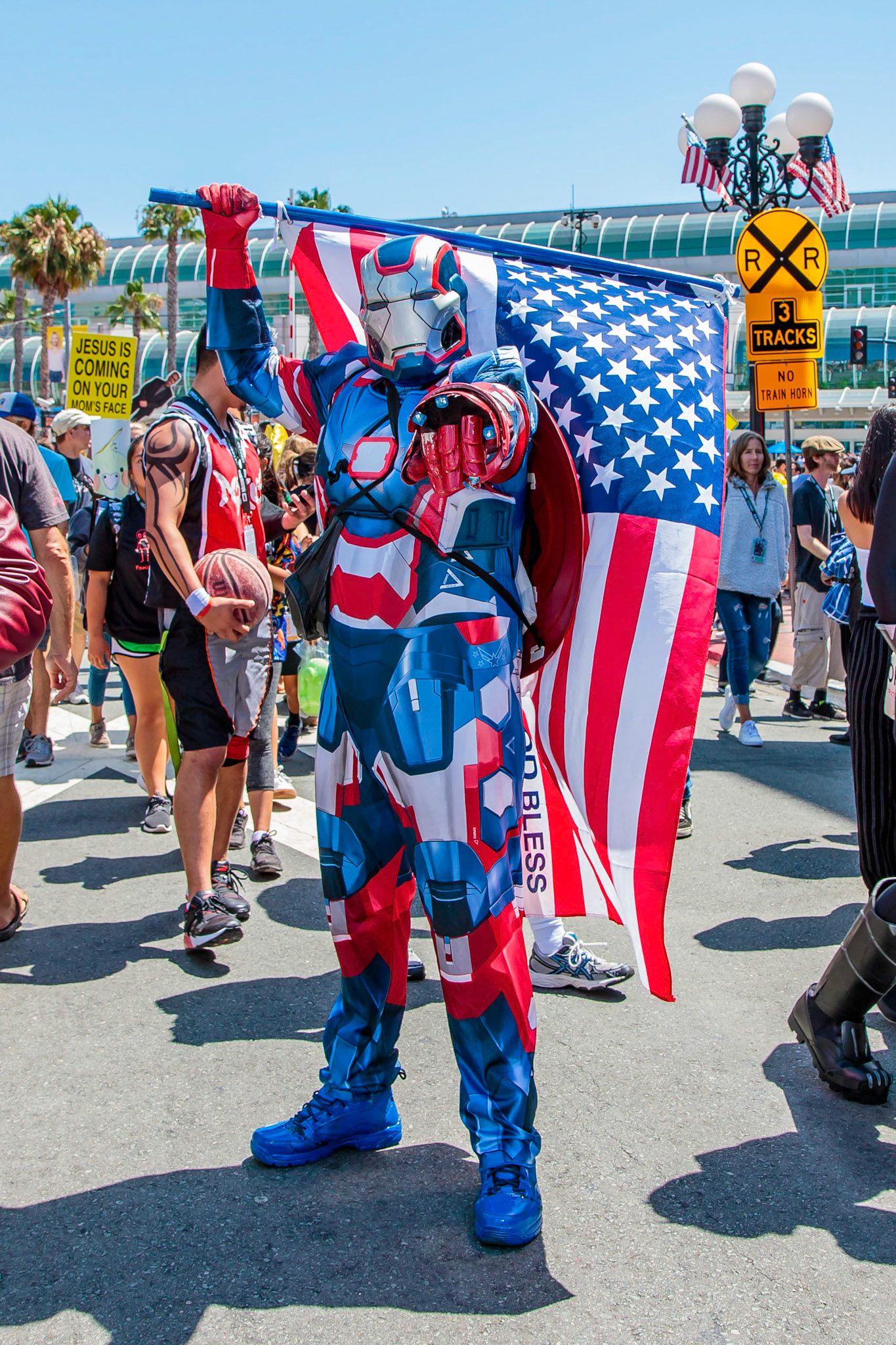 A cosplayer  dressed as Marvel's the Iron Patroit  walk the gaslamp at Comic-Con 2018 in San Diego on Friday, July 20, 2018.
