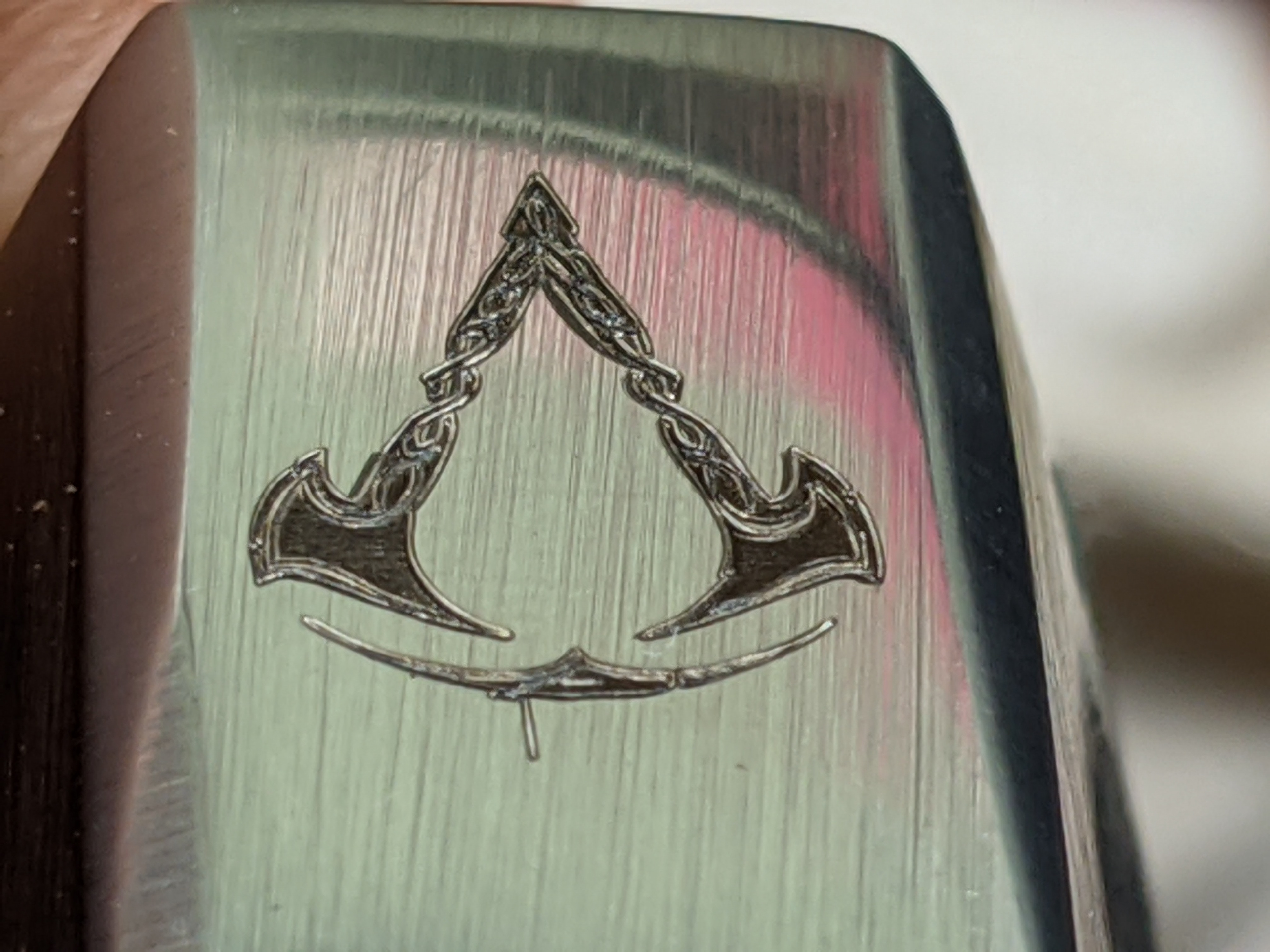 Closeup of Assassin's Creed Valhalla symbol engraving completed with µm [micrometer] precision
