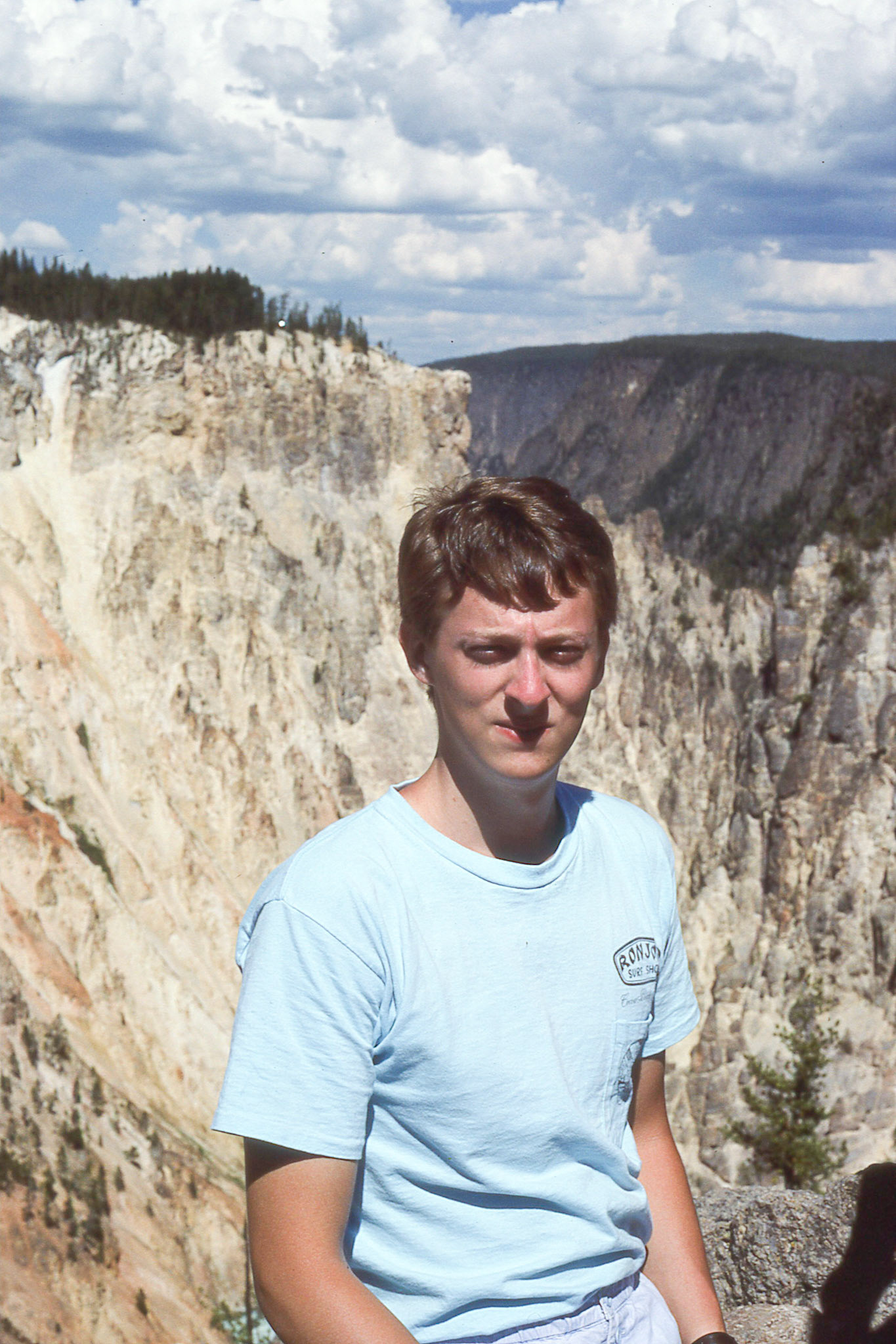 Barry attempts to keep his eyes open facing the sun. This view is facing opposite the Upper Yellowstone Falls.