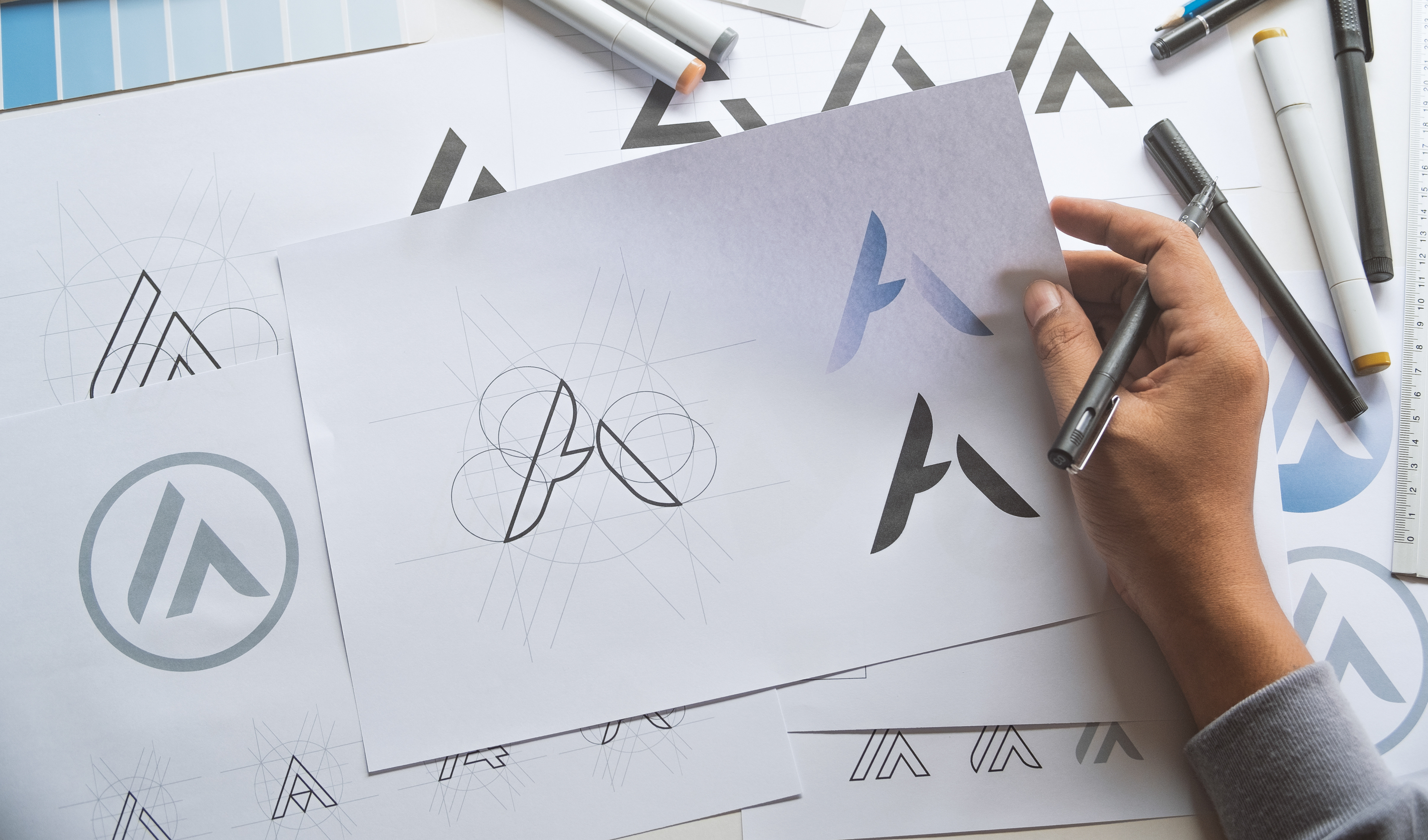 Graphic designer development process drawing sketch design creative Ideas draft Logo product trademark label brand artwork.
