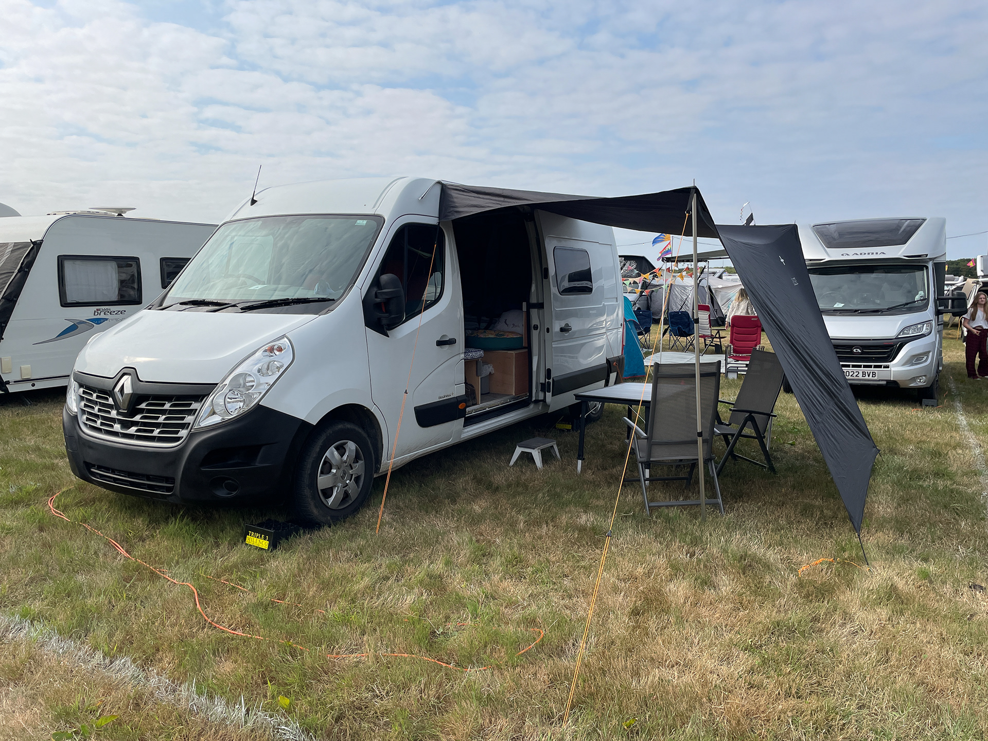 Awning rail and a simple tarp awning provide 'outdoor' space