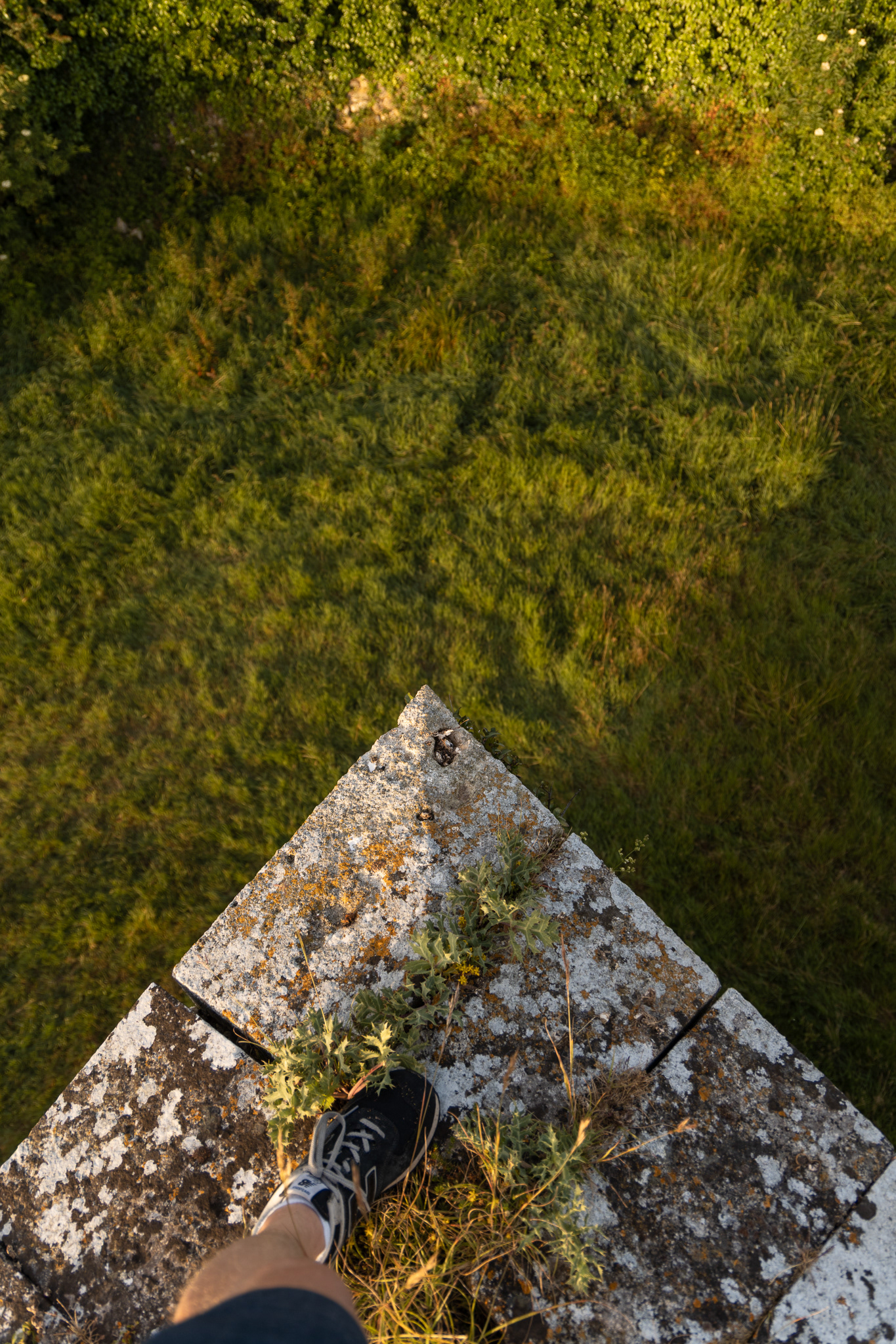 Standing on the edge of one the battlement walls. 