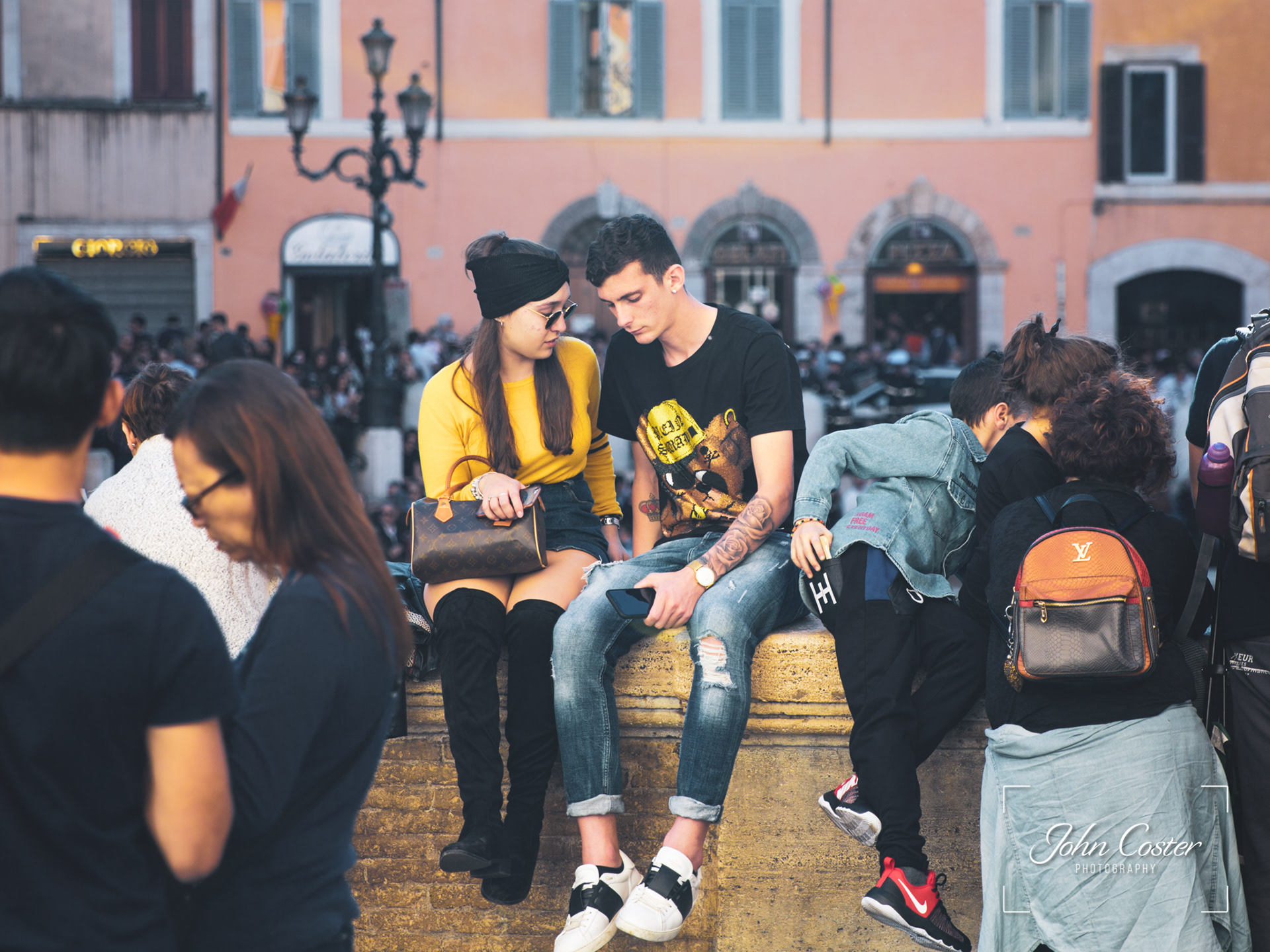 A young couple in the crowds at the Trevi Fountain