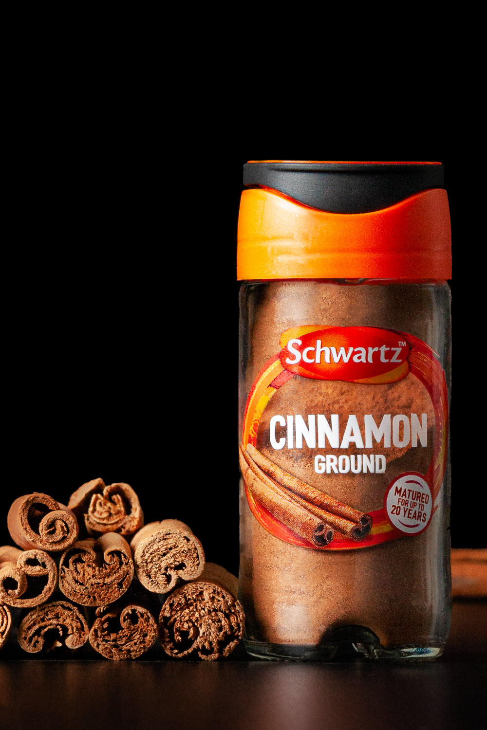 Cinnamon in jar with cinnamon sticks on the side