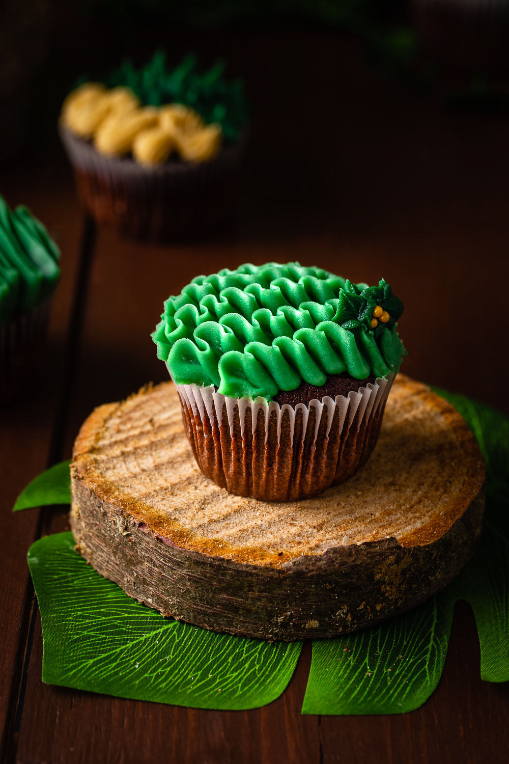 Chocolate cupcake with green icing on wooden board