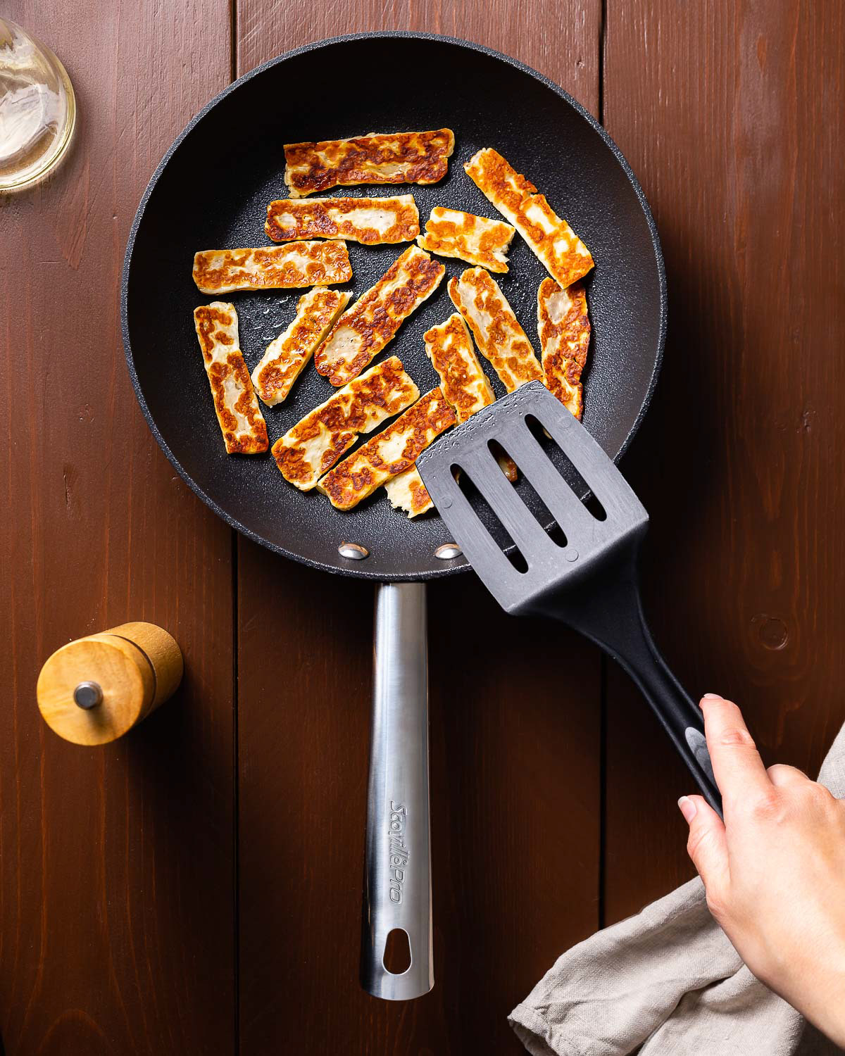 Halloumi cheese being fried in the pan