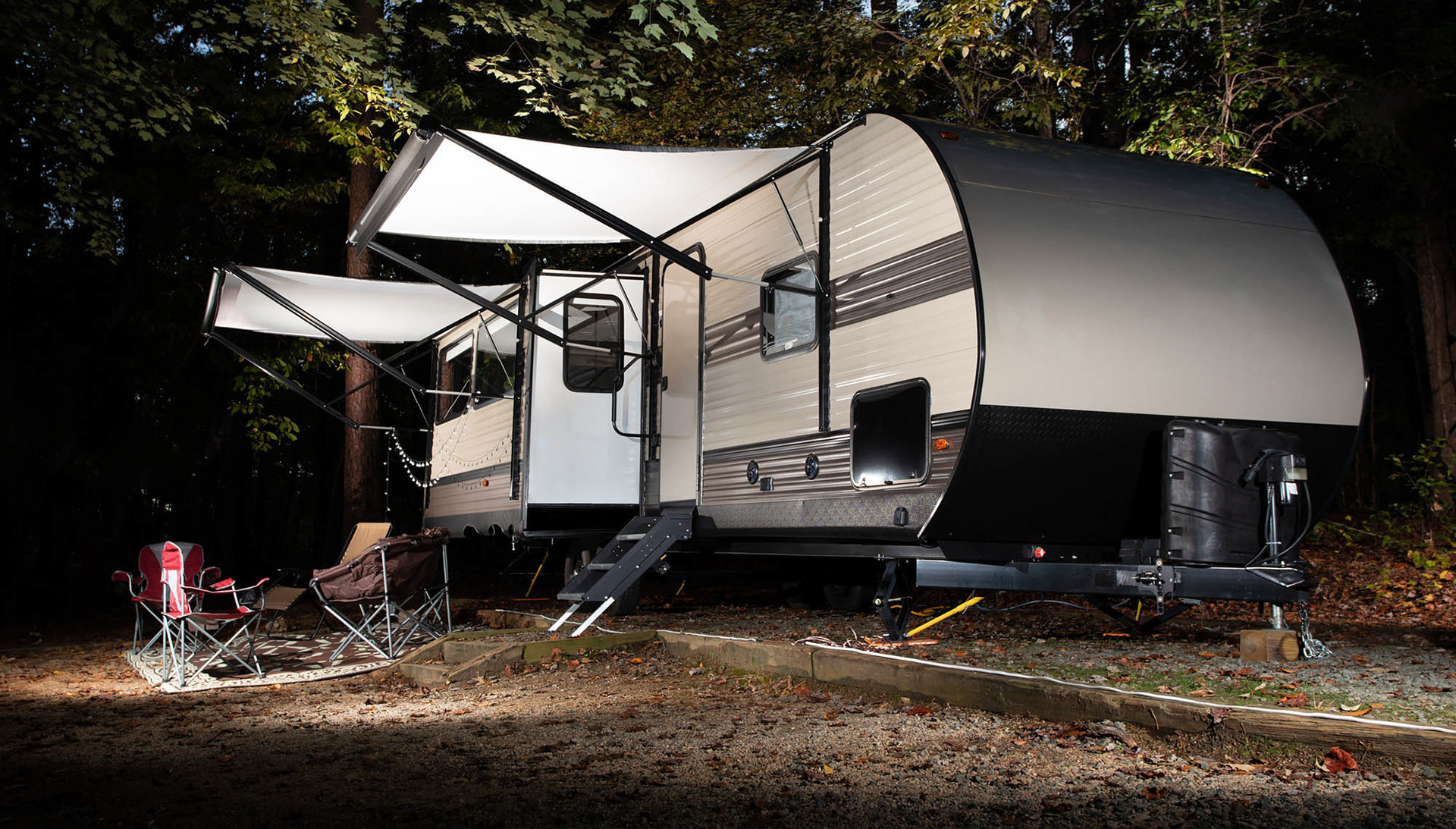 Camping trailer and camp set up at night at Falls Lake by Guy Sagi
