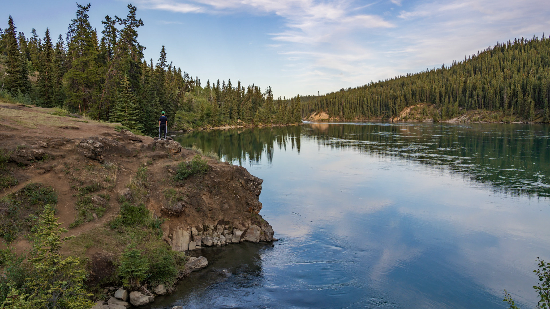 My son checking out the vastness of the Yukon River near Whitehorse.