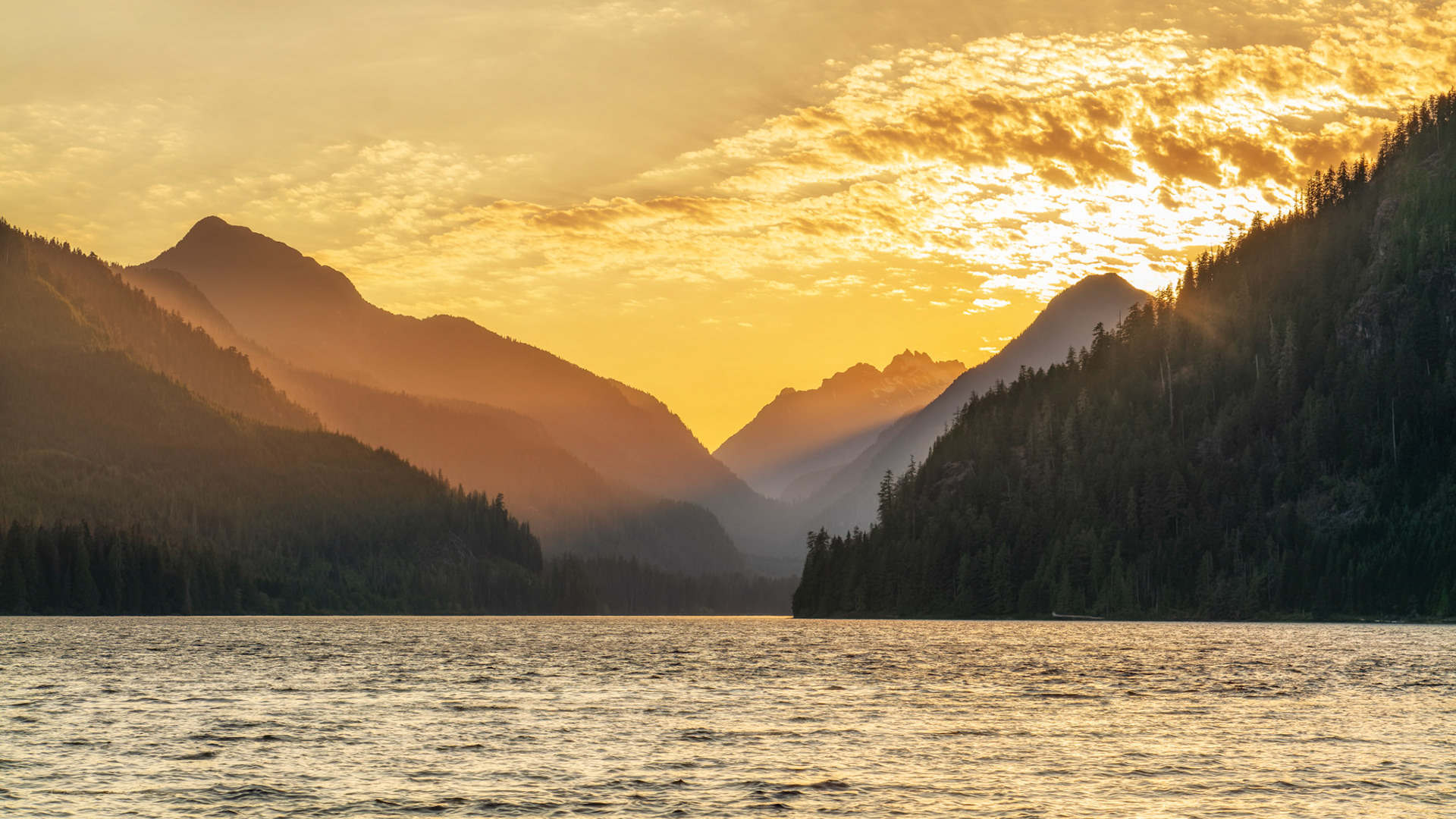 Sunsetting behind the mountains of Muchalat lake near Gold River on Vancouver Island, British Columbia, Canada.