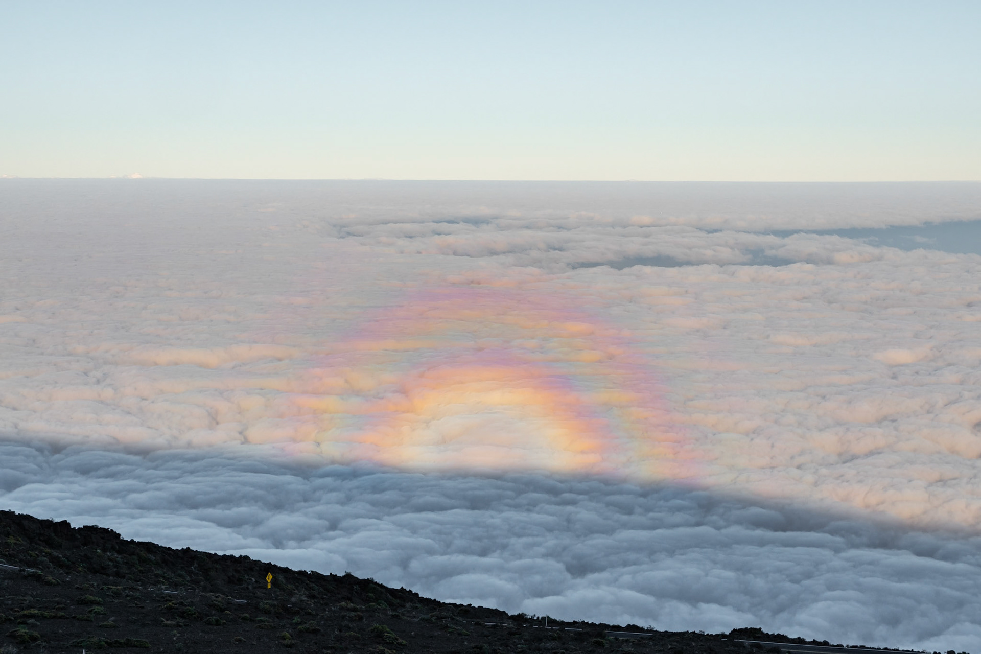 I have seen many rainbows in my day but this is the first time I have ever seen a rainbow above the clouds. My wife and I had just finished photographing a beautiful sunrise above the clouds and saw this on the way back down the mountain. Not sure why this happens but was glad I got a change to whitness it.