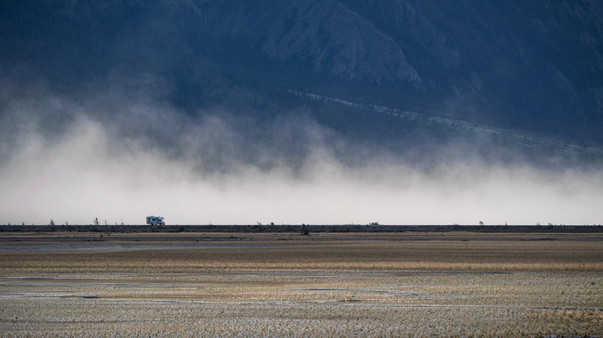 Wind blowing the sand of the Aay Chu Valley behind the only road through Kluane National Park in the Yukon.