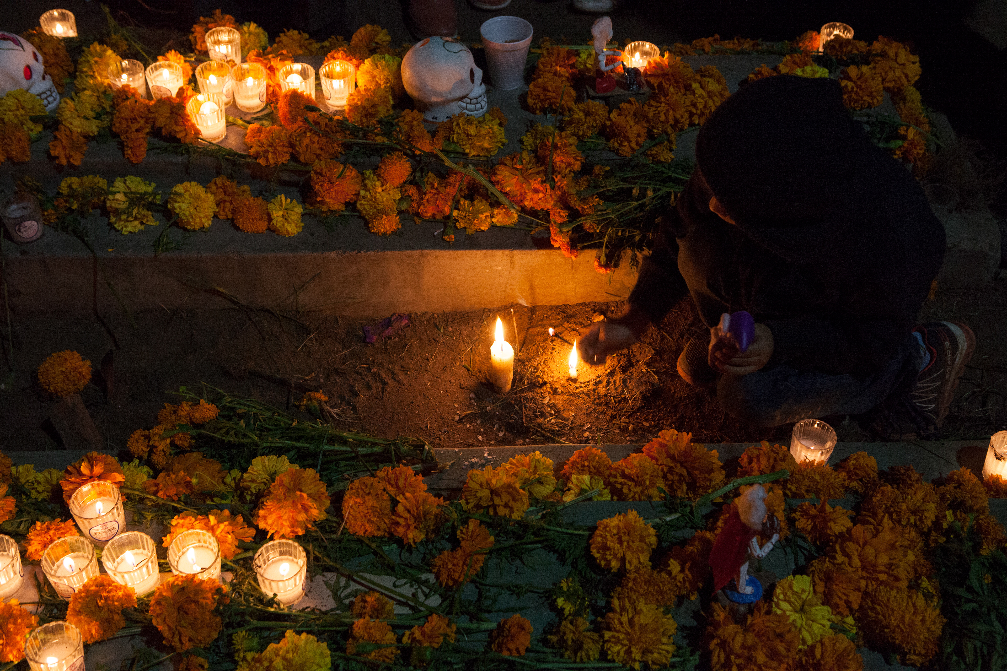 A child honoring his ancestors during the Day of the Dead in Oaxaca by Juan Escobedo