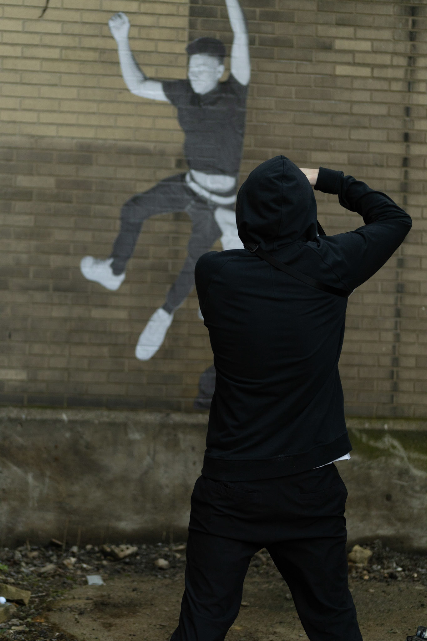 Jacob Wilkes, while taking pictures of street art he has worked on, enters and explores the Abandoned Train Station in Syracuse. Taken on 04/04/2022. Outside the old train station, Jacob takes a picture of another piece he put up.