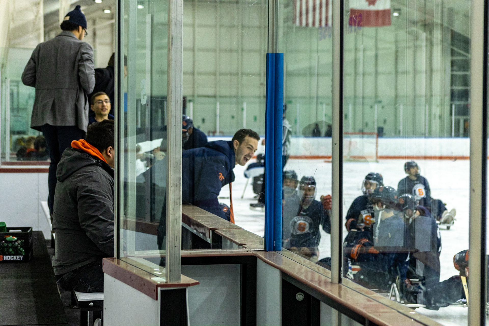 The CNY Flyers, a sled hockey team, played against the Syracuse University Men's Club Hockey team on 11/19/22 at Tennity Ice Skating Pavilion. The game ended with the Flyers scoring 8 to Syracuse 0 with 25 shots on goal by the Flyers compared to Syracuse's 2. While the game was still competitive, it was more for the fun of the sport with smiles shared by all. It was also a new experience for the Syracuse team which consisted of able-bodied individuals who may have never experienced sled hockey. Syracuse coaches hype up their team members during half time.