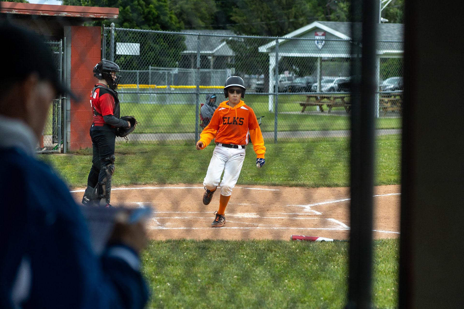 Connor Stepien (#91) casually touches home adding another point to his team, the Elks, score. The Elks would win 19-10 against the Firefighters on June 18th at Lagoe field.