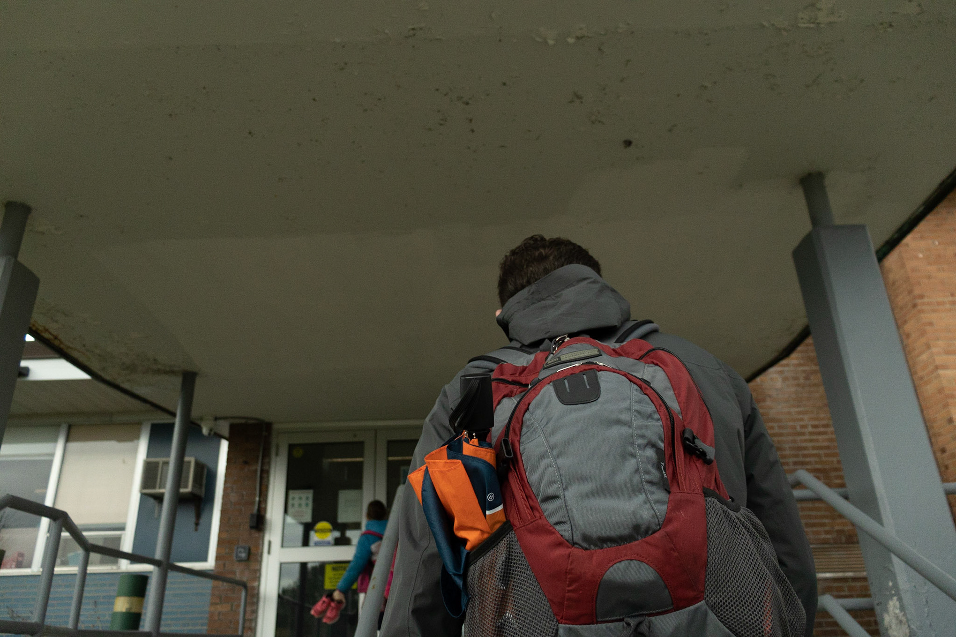 Hunter Franklin captures images of a local Syracuse Rabbi at a Jewish Pre-School for his VIS 425 Project. Images taken 04/06/22. Hunter walkes through the doors of the School. The doors are thick with bulletproof glass.
