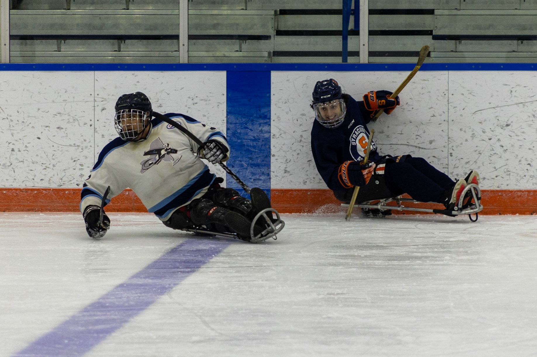 The CNY Flyers, a sled hockey team, played against the Syracuse University Men's Club Hockey team on 11/19/22 at Tennity Ice Skating Pavilion. The game ended with the Flyers scoring 8 to Syracuse 0 with 25 shots on goal by the Flyers compared to Syracuse's 2. While the game was still competitive, it was more for the fun of the sport with smiles shared by all. It was also a new experience for the Syracuse team which consisted of able-bodied individuals who may have never experienced sled hockey. #5 for the Flyers, Rick Symanski, turns sharply to return to the action.