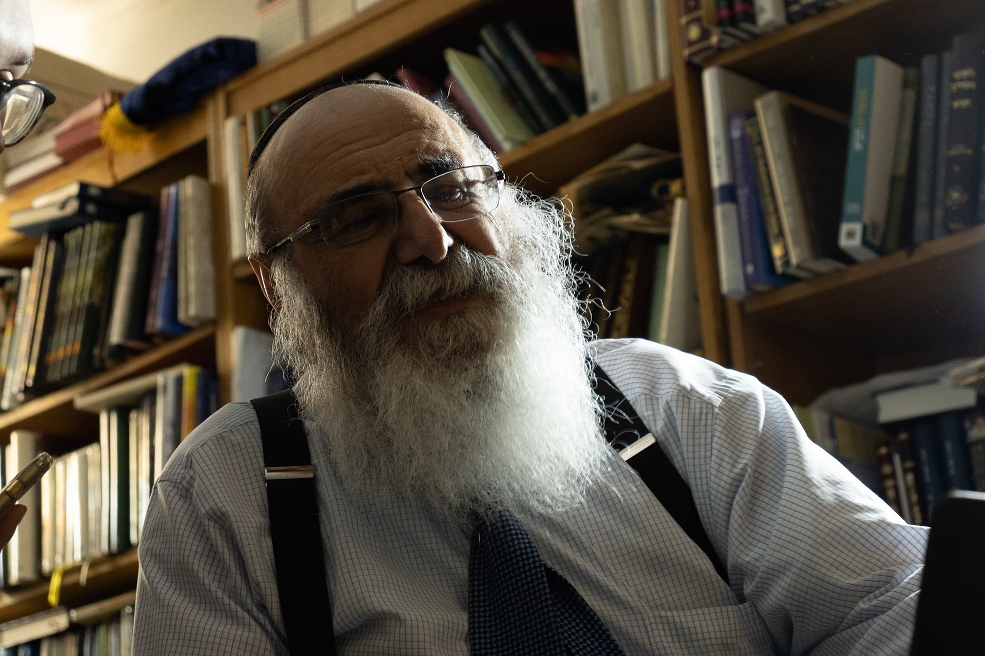 Hunter Franklin captures images of a local Syracuse Rabbi at the Rabbi's home for his VIS 425 Project. Images taken 04/26/22. The Rabbi sits merrily in his home as Hunter shows him the pictures he has gotten so far.