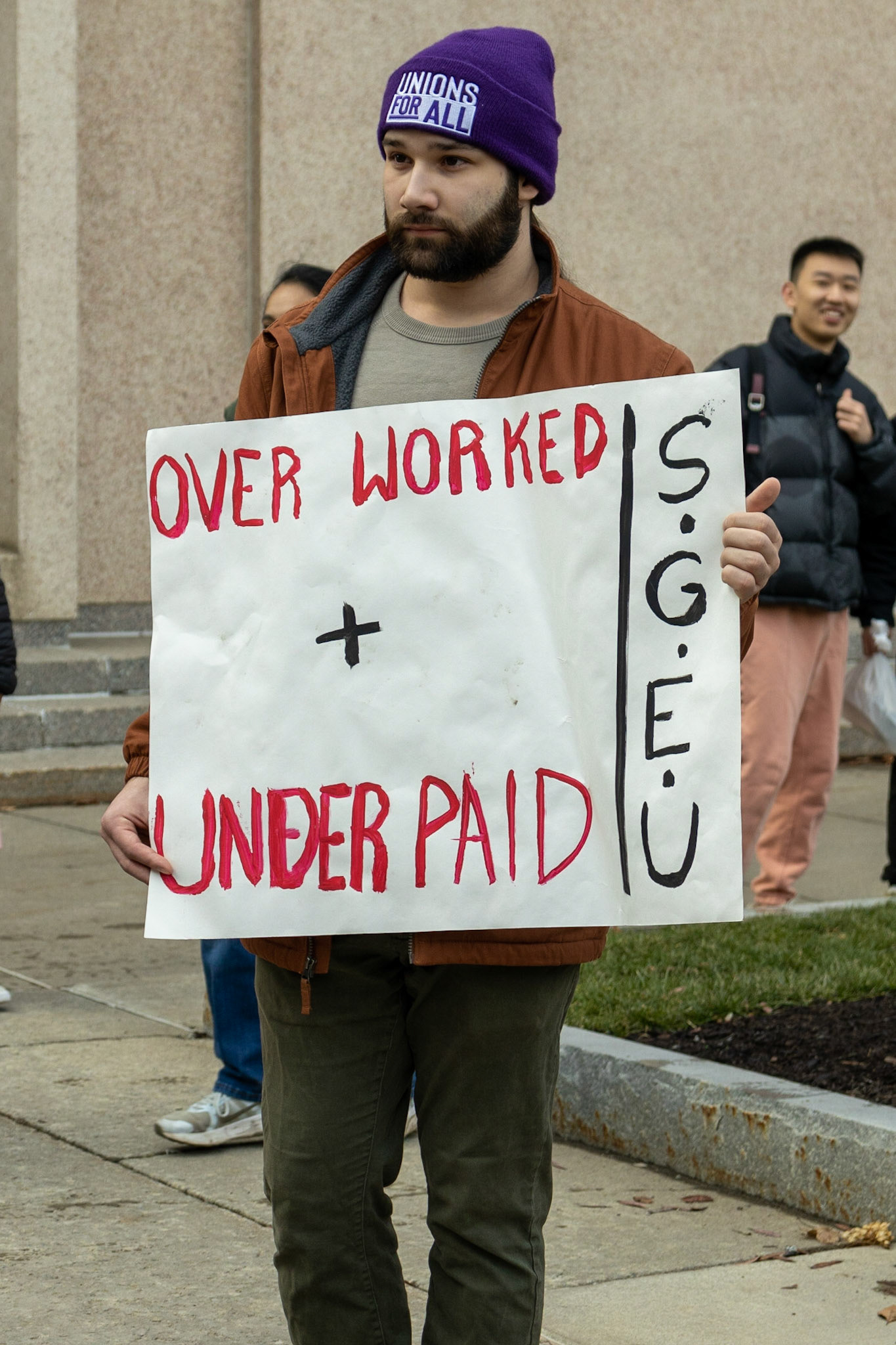 The Syracuse Graduate Employees Union gathered fellow students, supporting faculty and staff, as well as regular observers at the steps of Carnegie Library as they advocated for the University to recognize the union and accept the union's demands. The group then marched to the student center and onwards to the administration building where leaders would meet with the Provost.