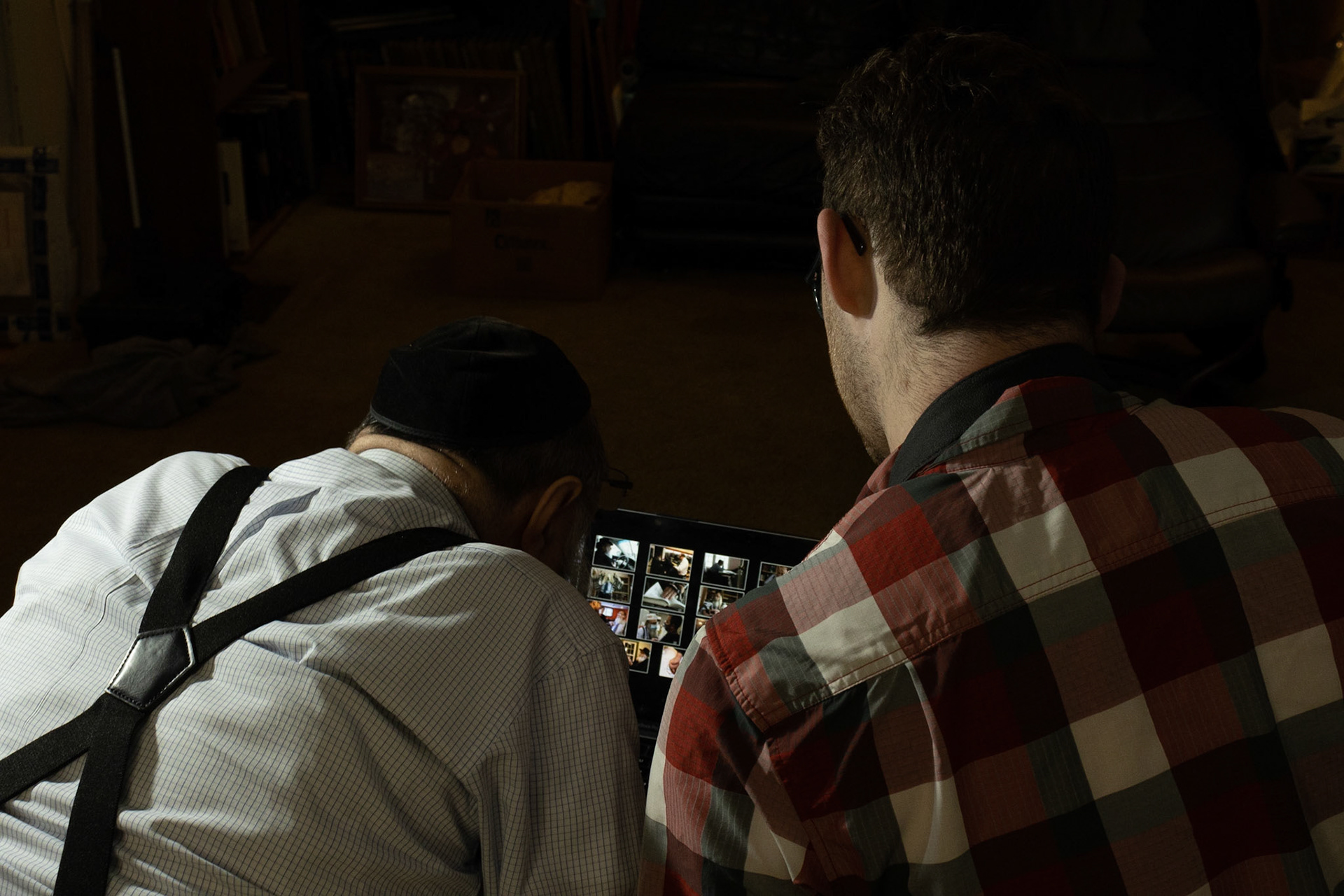 Hunter Franklin captures images of a local Syracuse Rabbi at the Rabbi's home for his VIS 425 Project. Images taken 04/26/22. The Rabbi sits merrily in his home as Hunter shows him the pictures he has gotten so far.