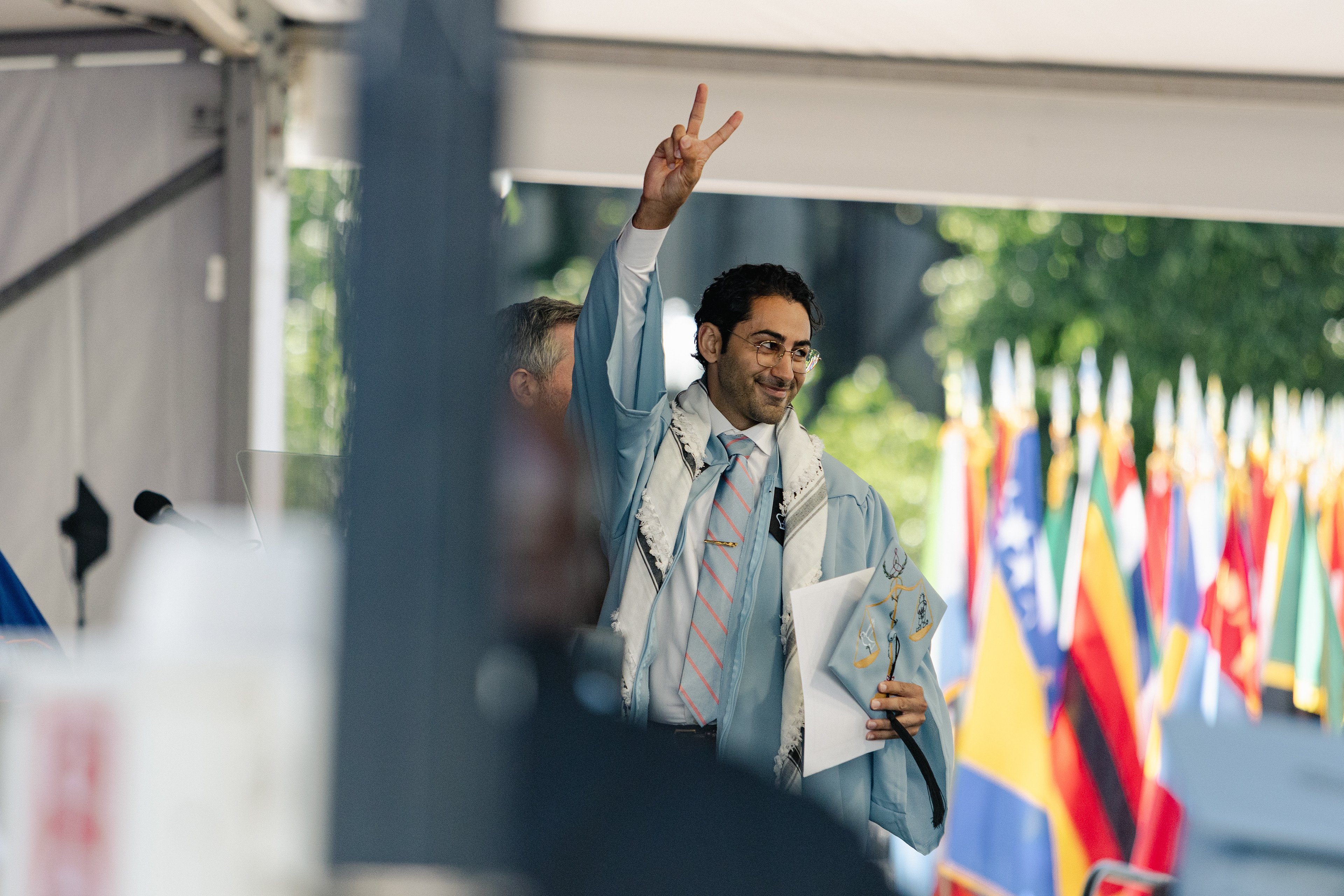 Mohsen Mahdawi crosses the graduation stage at Columbia