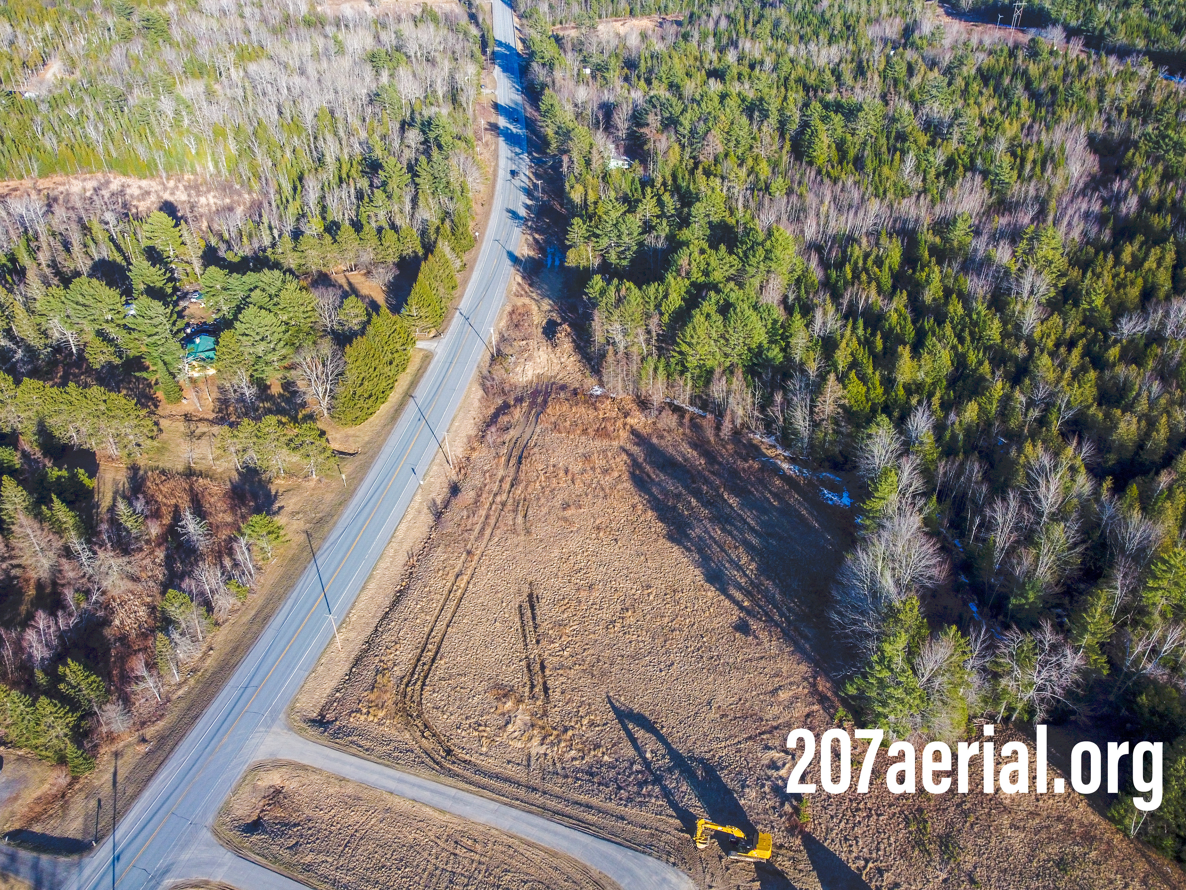 A tractor sits where there once was a farm with horses. Eddington, Maine. (April 2023)