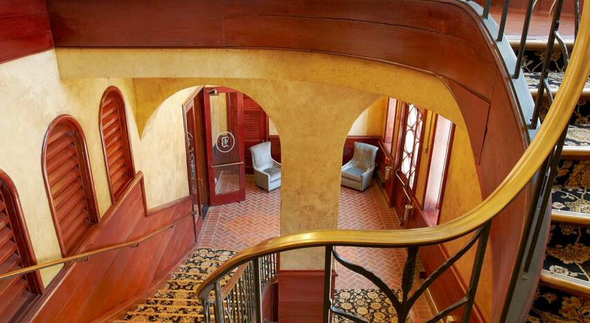 Original winding staircase leading to lobby