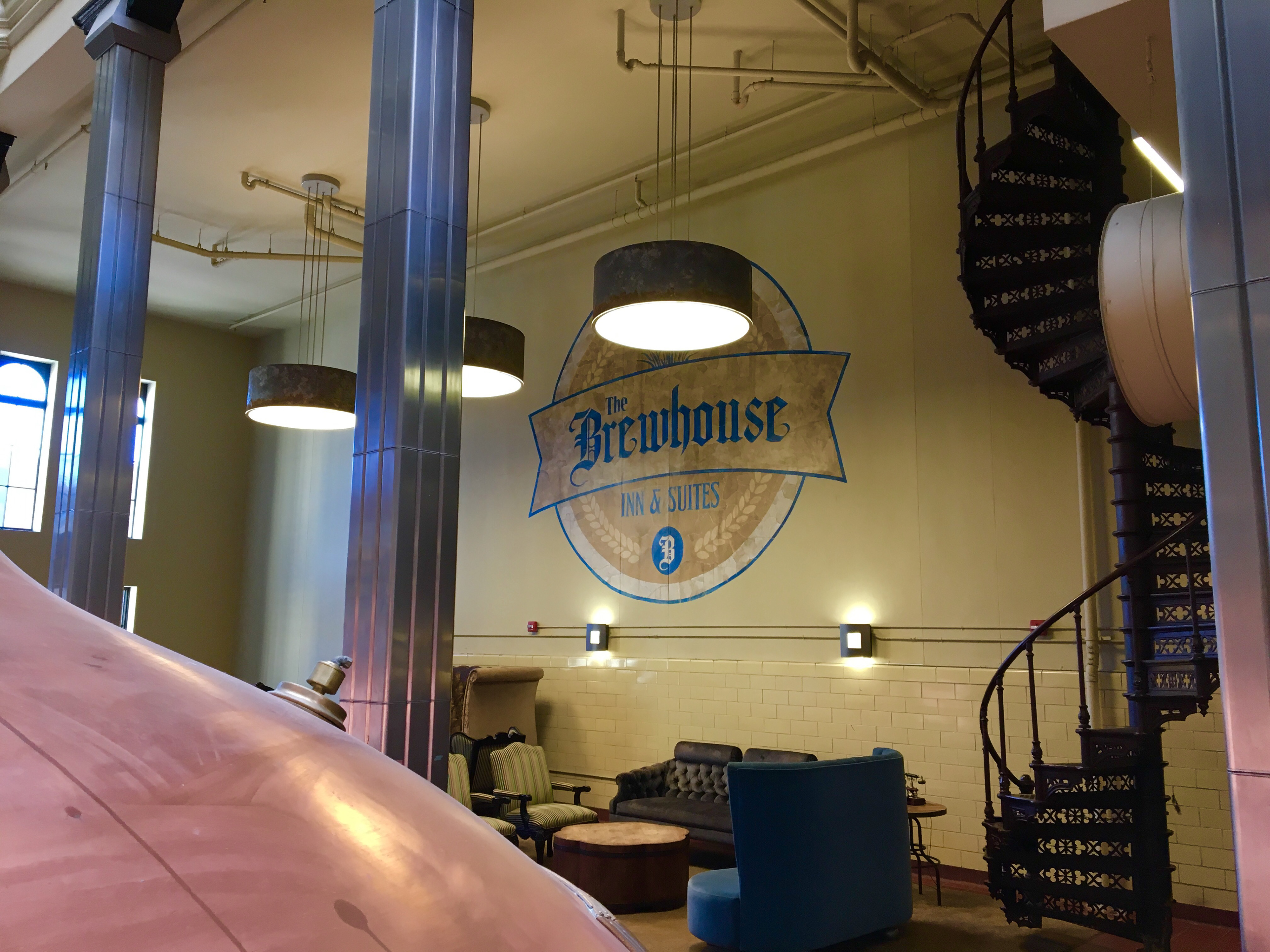 Second floor atrium lounge area with original copper brewing kettles