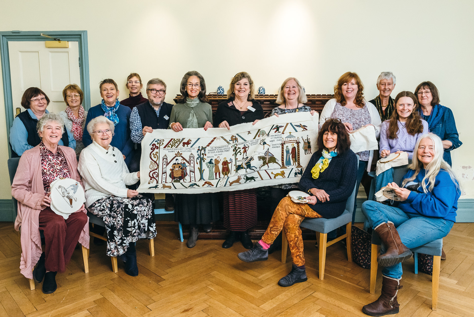 The embroidery team with the first completed panel. Photo: Norfolk Museums service
