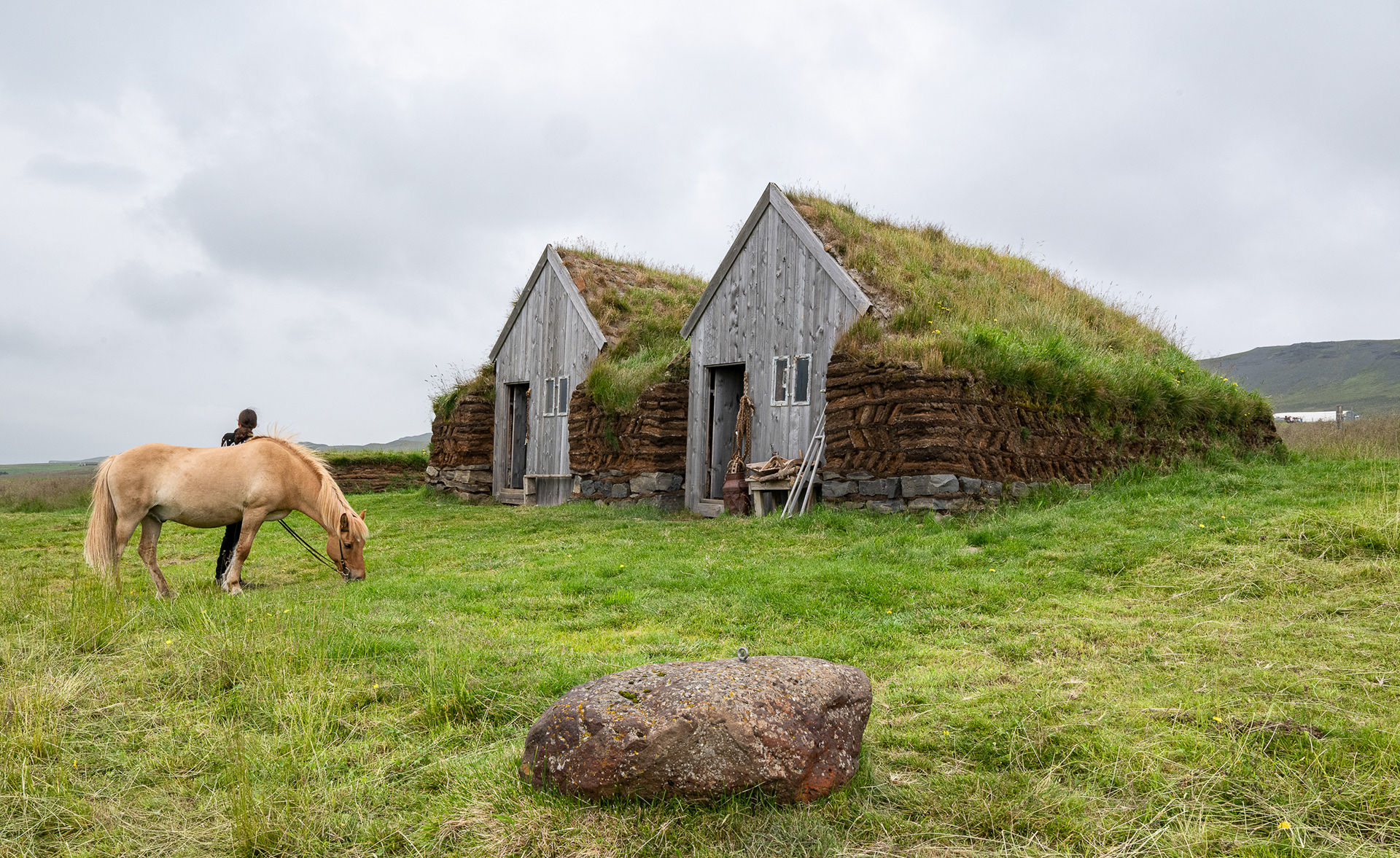 Sod house structures outside horse farm at Skagafjoraur