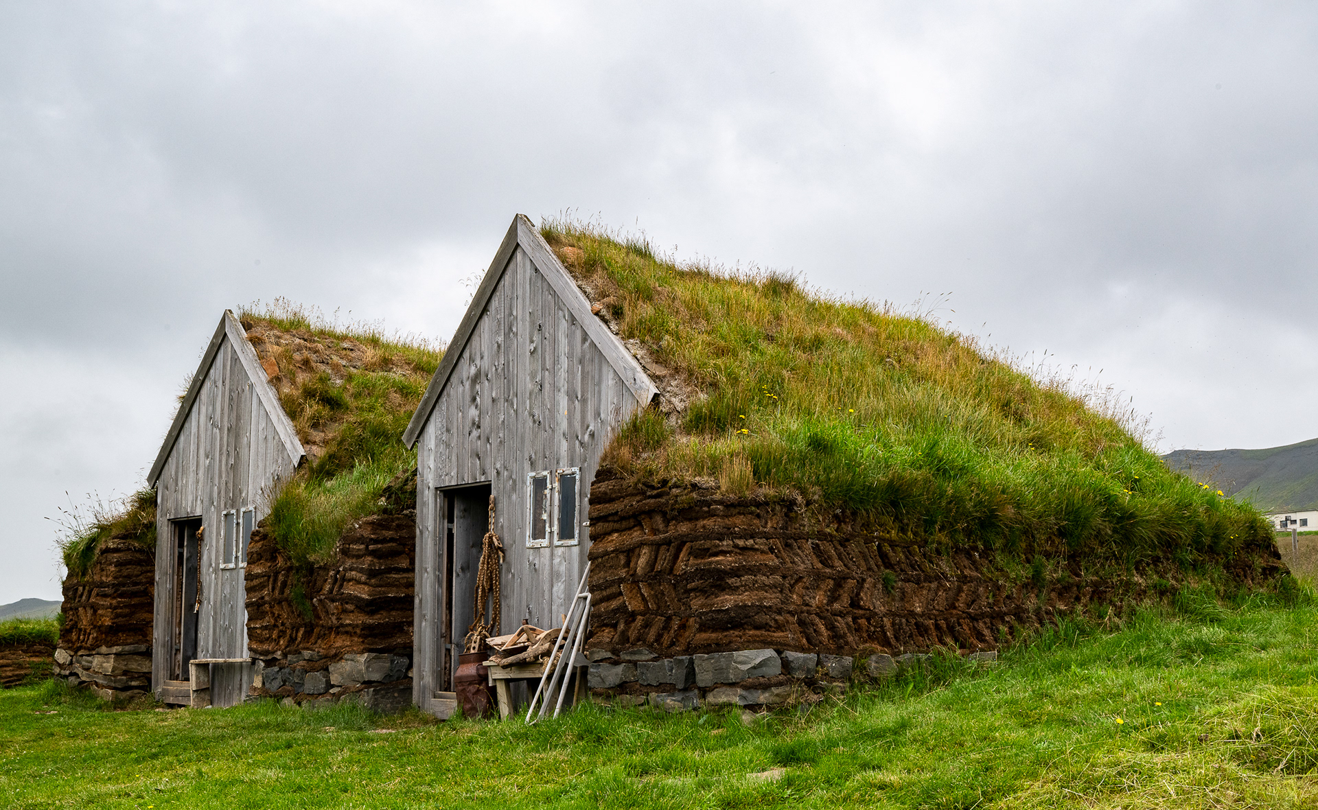 Sod house structures outside horse farm at Skagafjoraur