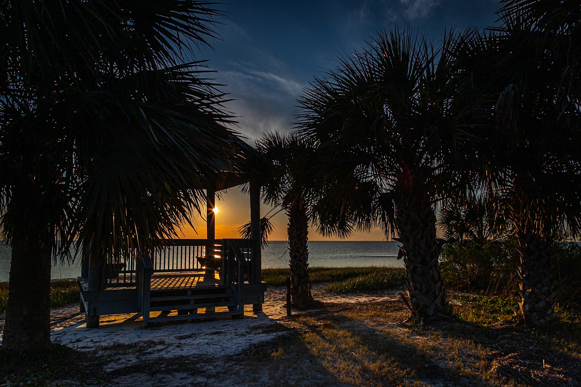 A sunburst at sunset at Gazebo by the gulf