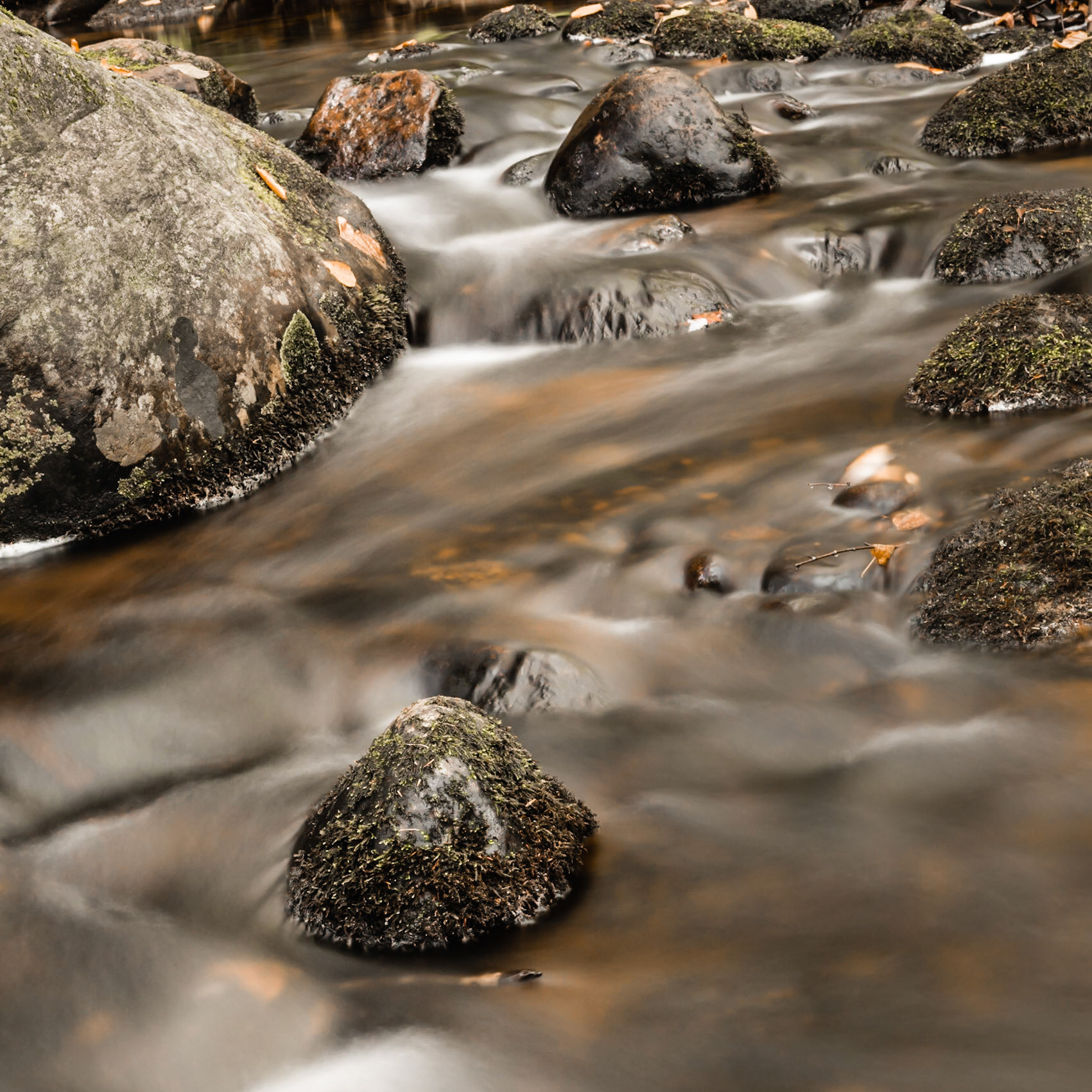 Rocks in soft flowing water in Pine Brook in the Adirondacks, New York.