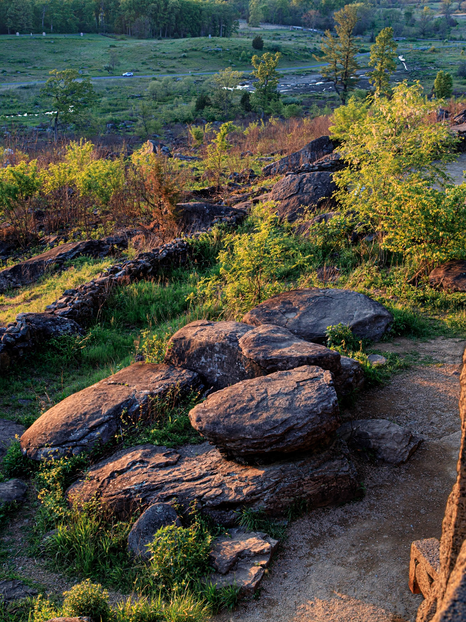 Soft evening light making the rocky hill side glow as sunset starts to arrive