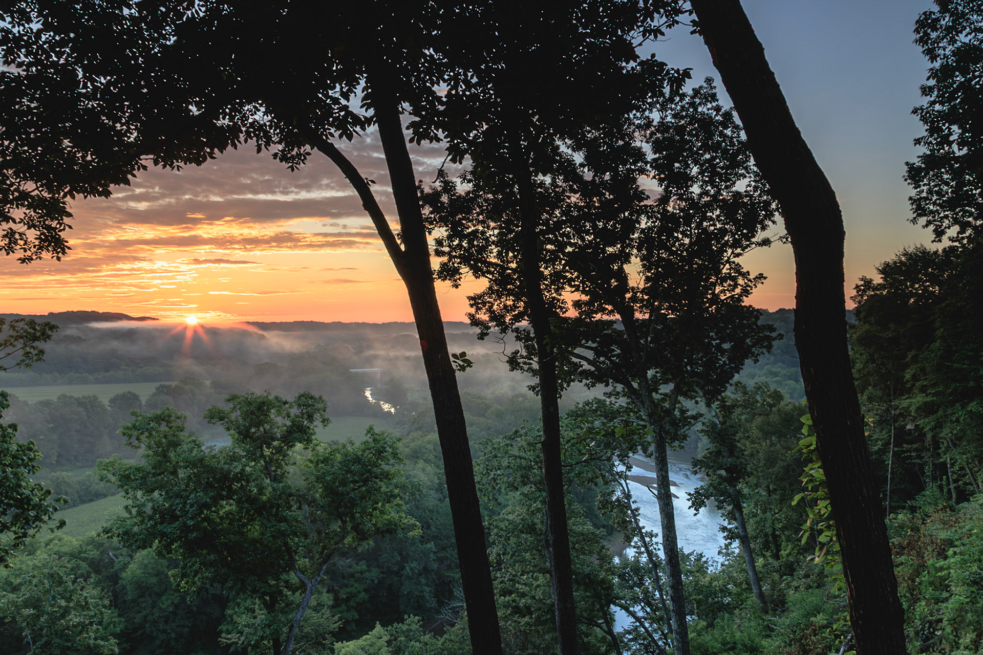 Duck river in the valley as sky turns golden with the sunrise