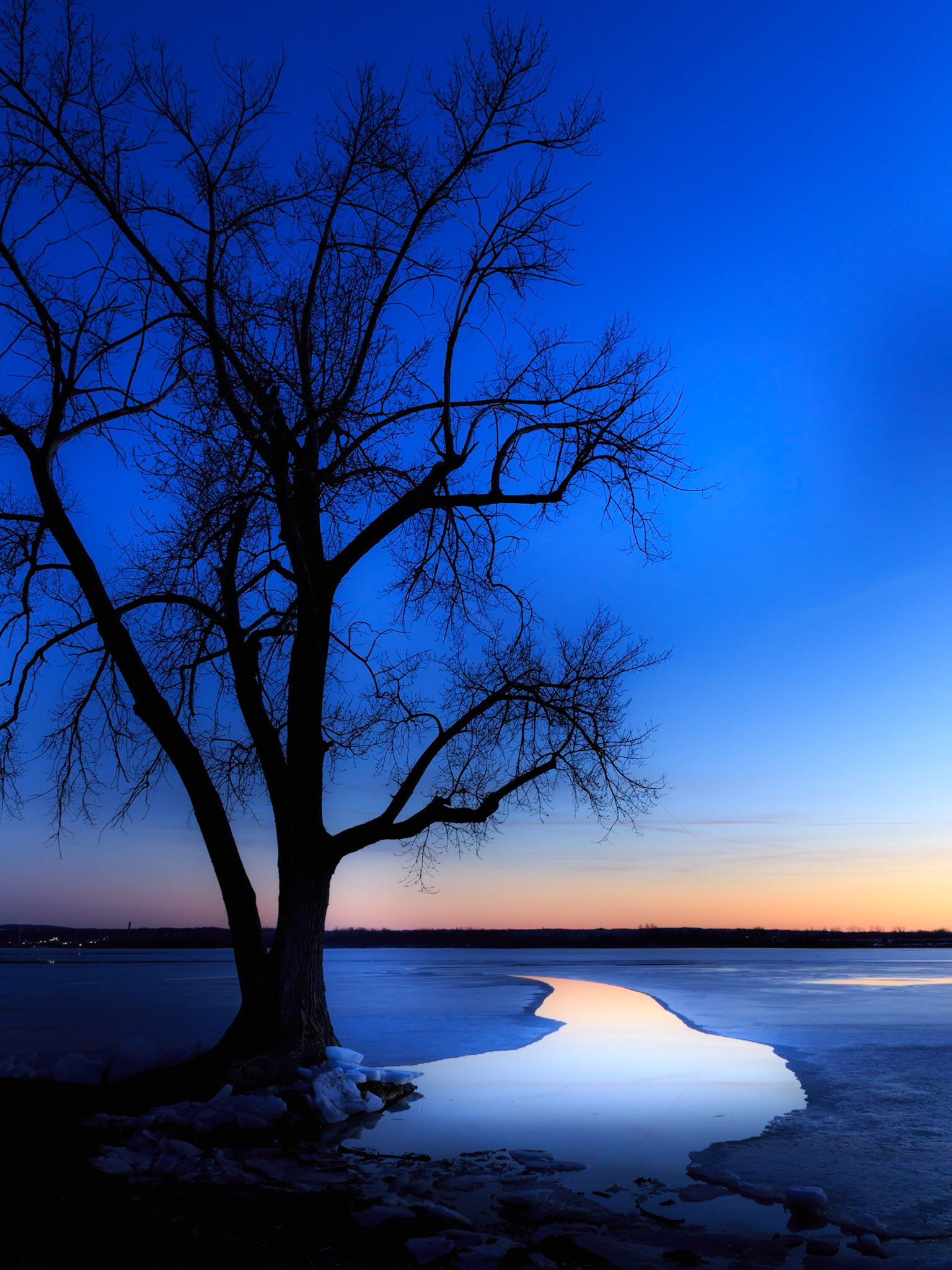 A meandering stream from the ice catches the last of  the sunset