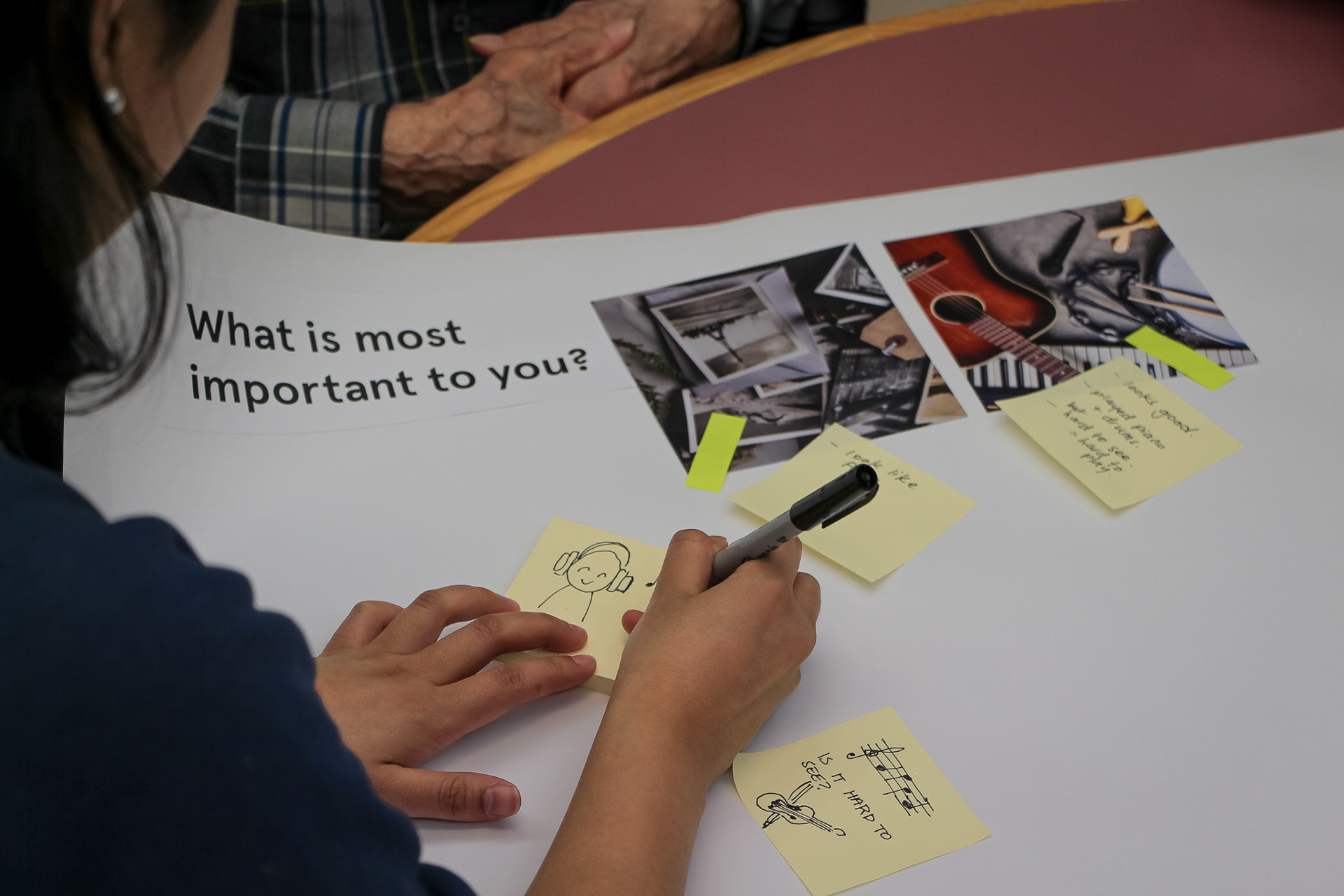 Laura communicates with a resident through drawings without an interpreter.