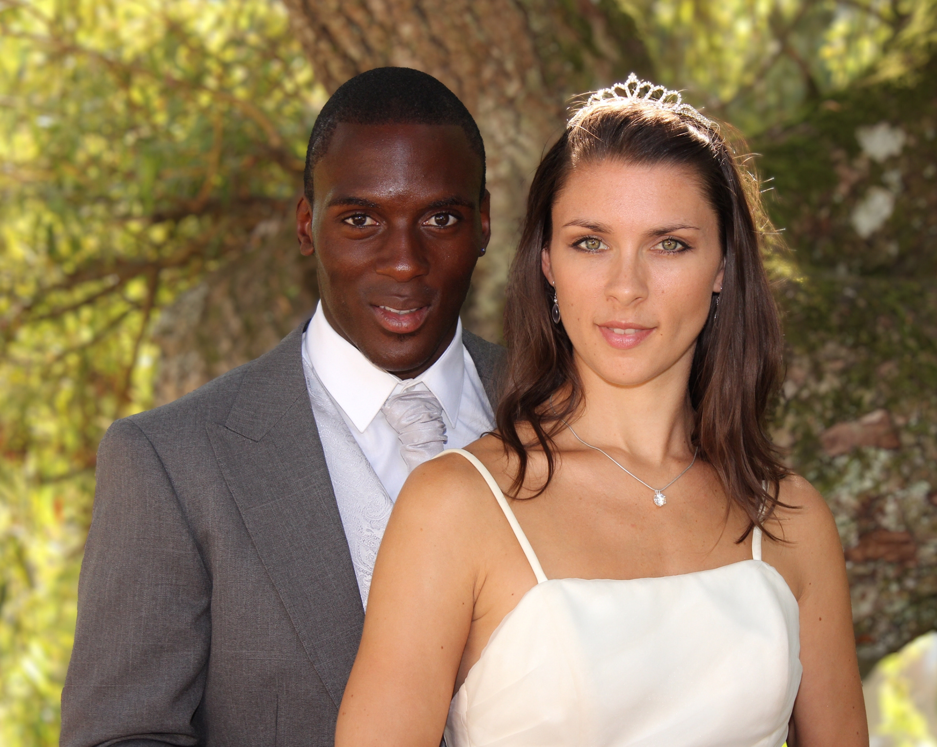 Bride and groom in front of a tree