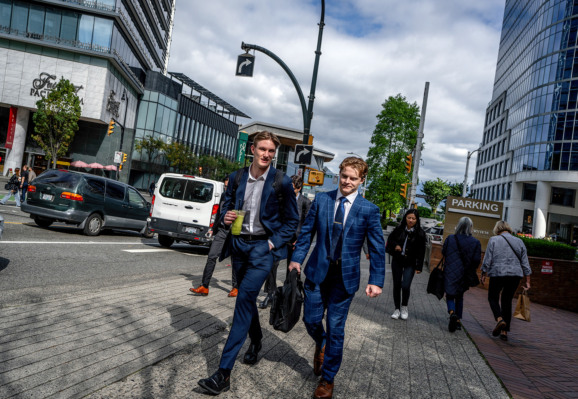 Two jocular young businessmen striding down the street, young turks making their way in the Markets!