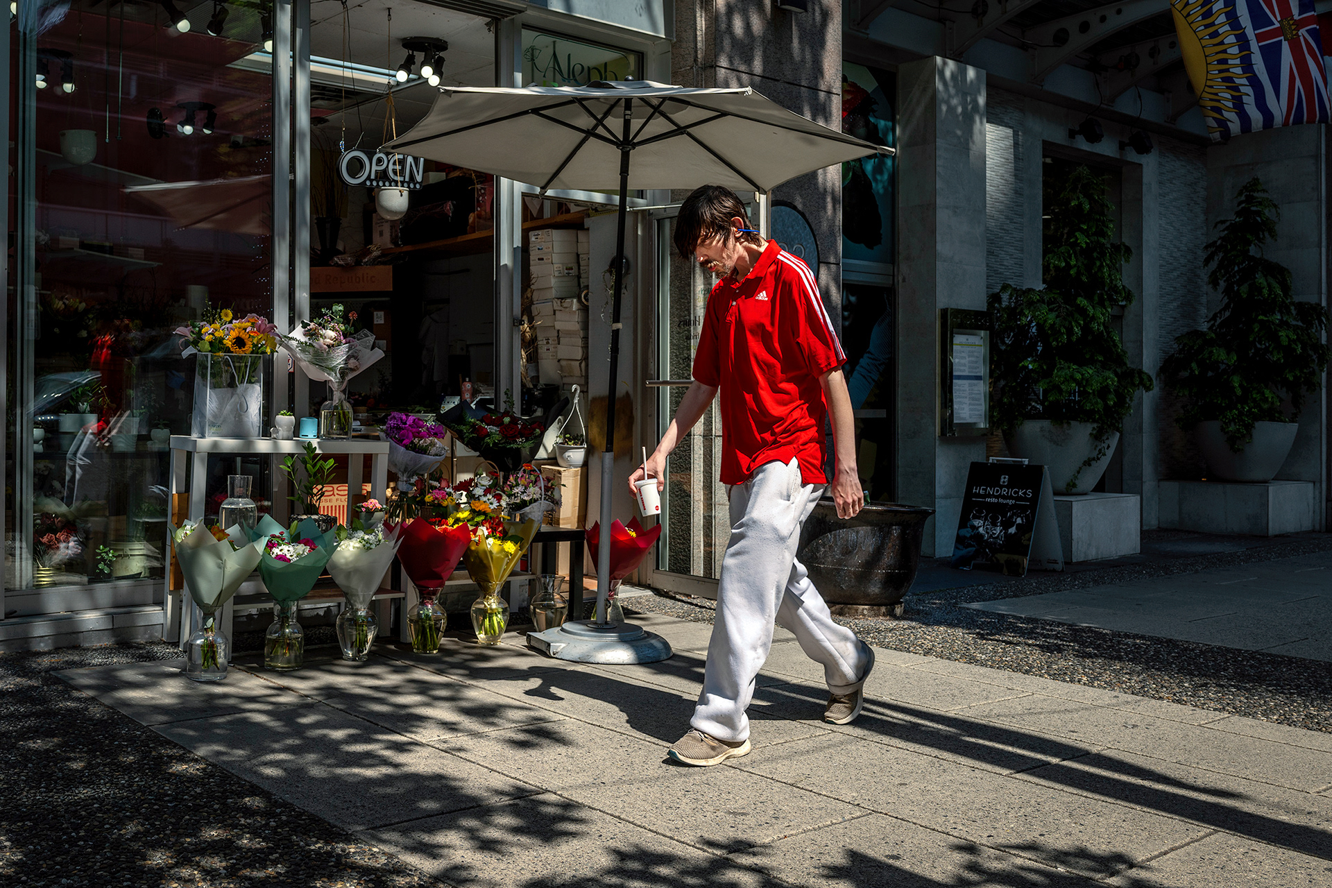 Flower shop and malevolent passerby in a red shirt.
