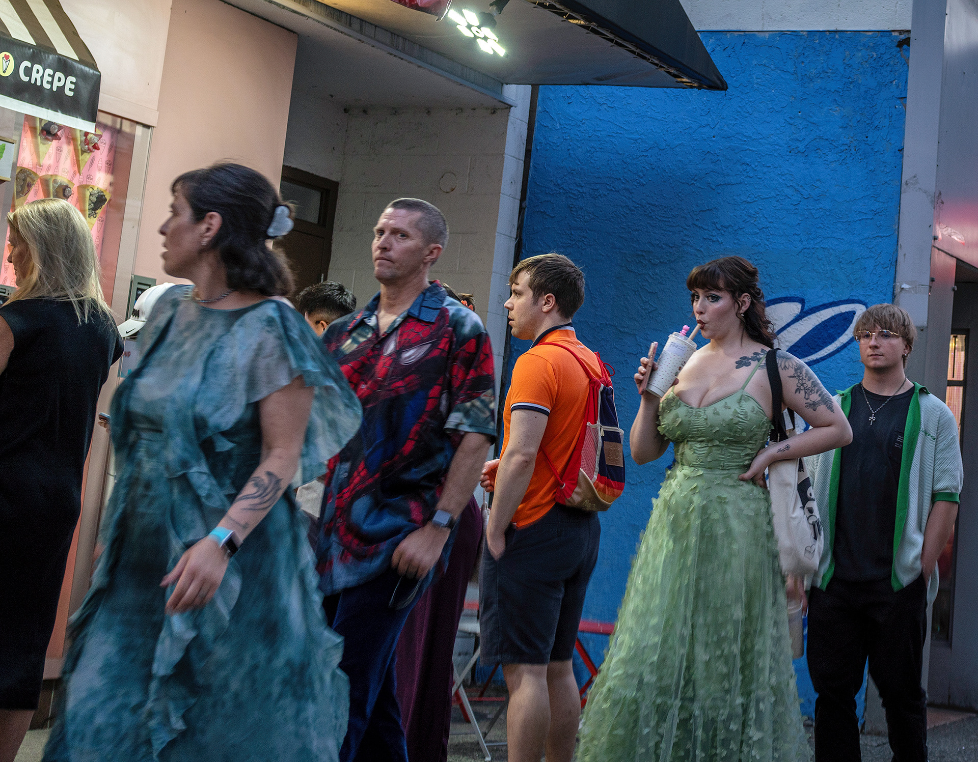 Colourful family on an evening stroll, angel wings and a green gown, Spidey eyes.
