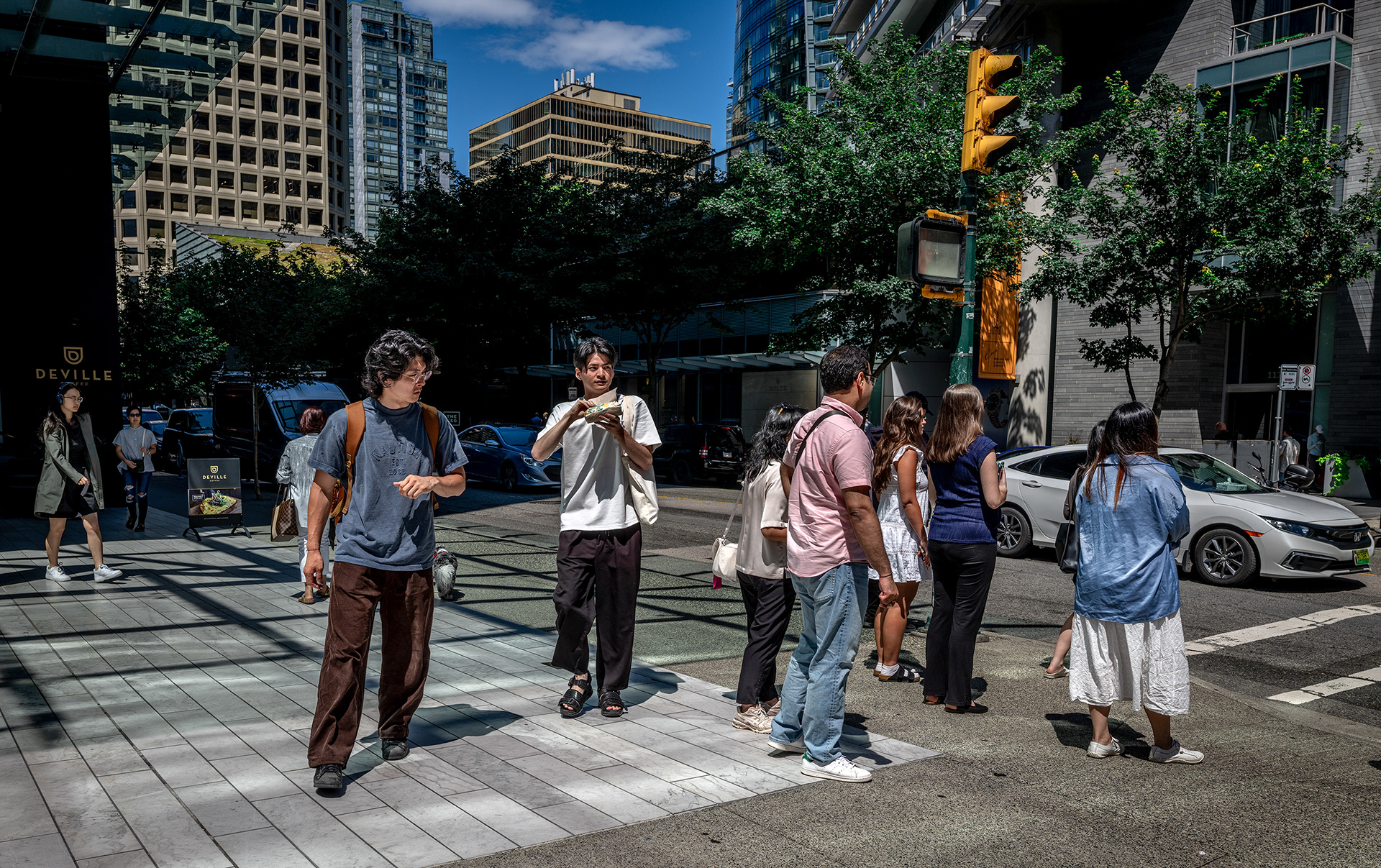 Two youn men stand out on the sidewalk, energetic an phhsical.