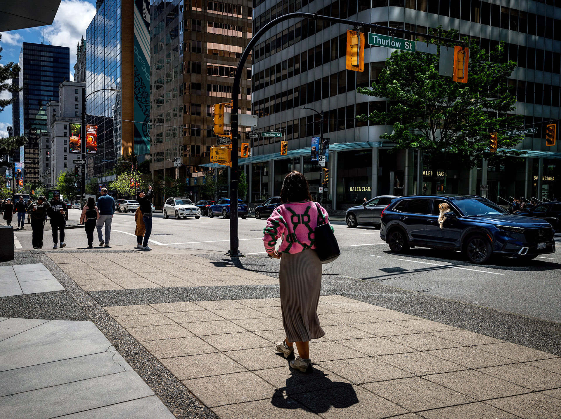 Thurlow Street downtown Vancouver, street photography, colorful scene with a dog viewing people from an open car window.