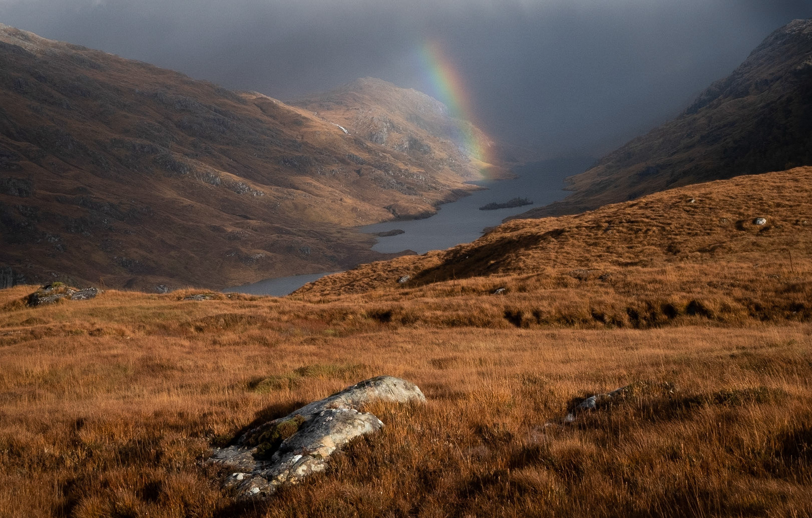 I was concerned that we had seen the last of the sunshine but it cleared again as we reached the path to Loch Beoraid so we set off up the hill. The path was atrocious - more or less a burn interspersed with deep bog and the walk took a bit longer than I had anticipated. We reached the bealach just as a shower of rain stopped, with a rainbow over the loch.