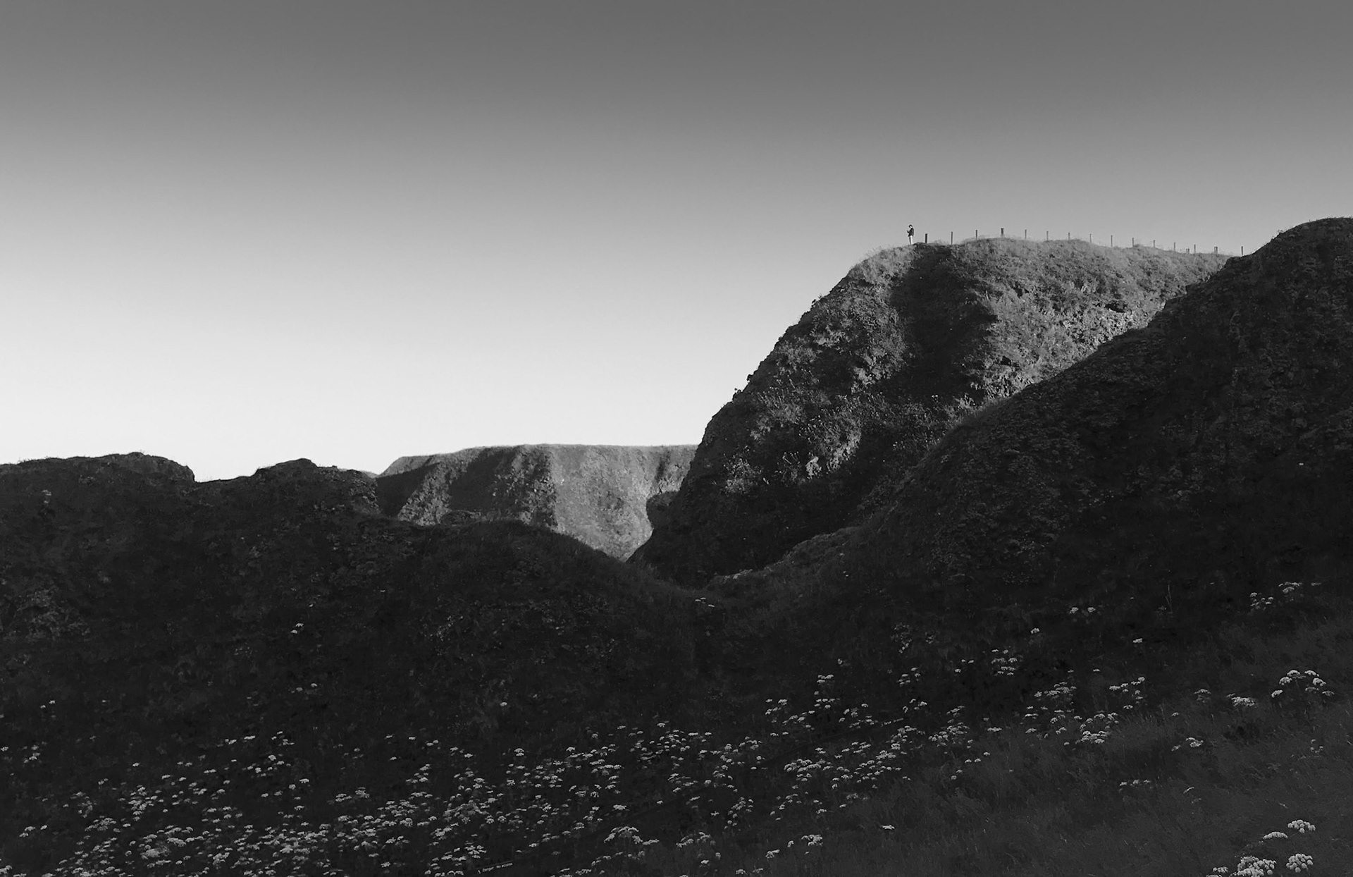 Looking up from the bay towards the cliffs, I spotted this lone figure on a headland. I thought it was more effective in mono than in colour.