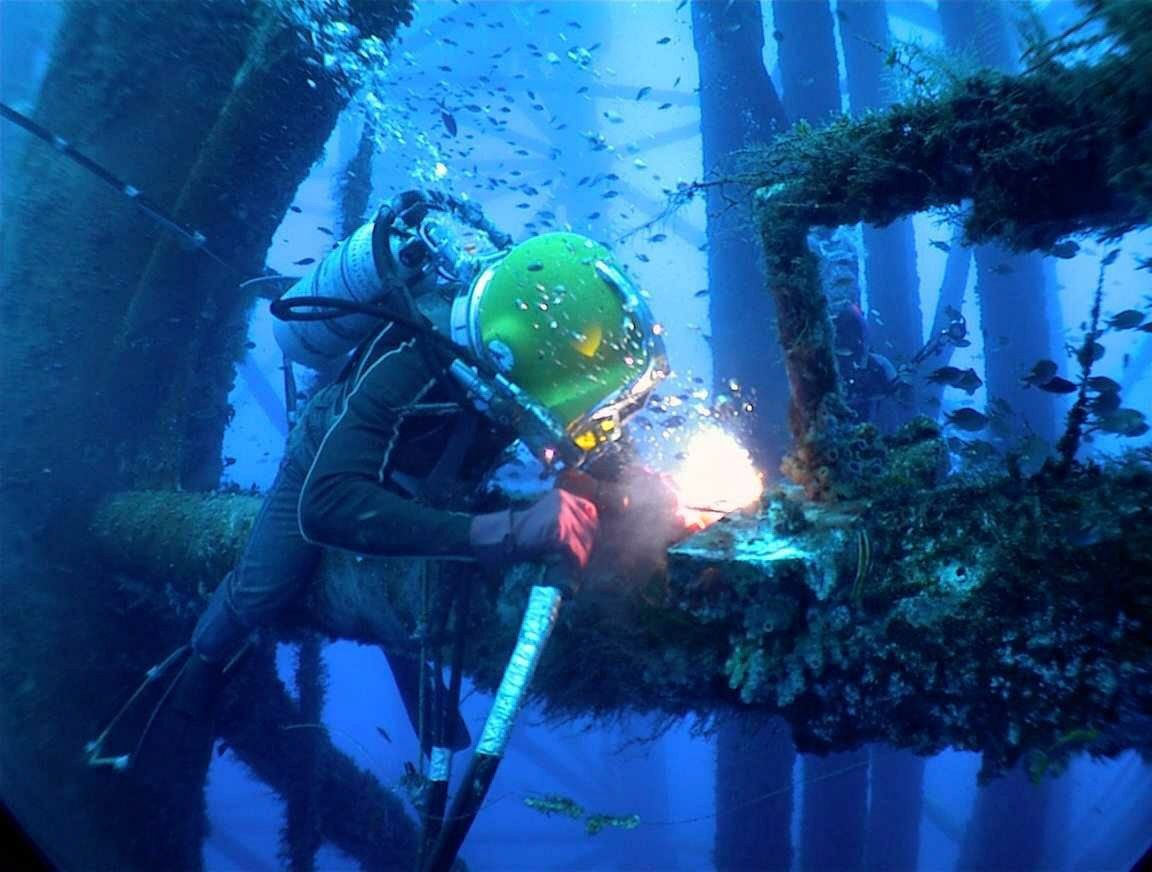 diver welding on platform leg