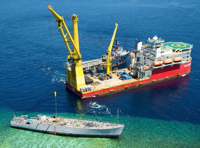 130312-N-VF350-059 SULU SEA (March 12, 2013) The U.S. Navy contracted vessels Jascon 25 and the tugboat Archon Tide are positioned next to the Avenger-class mine countermeasures ship ex-Guardian (MCM 5) during salvage operations.  Guardian ran aground on the Tubbataha Reef Jan. 17.  The U.S. Navy continues to work in close cooperation with the Philippine authorities to safely dismantle Guardian from the reef while minimizing environmental effects. (U.S. Navy photo by Mass Communication Specialist 1st Class Anderson Bomjardim/Released)