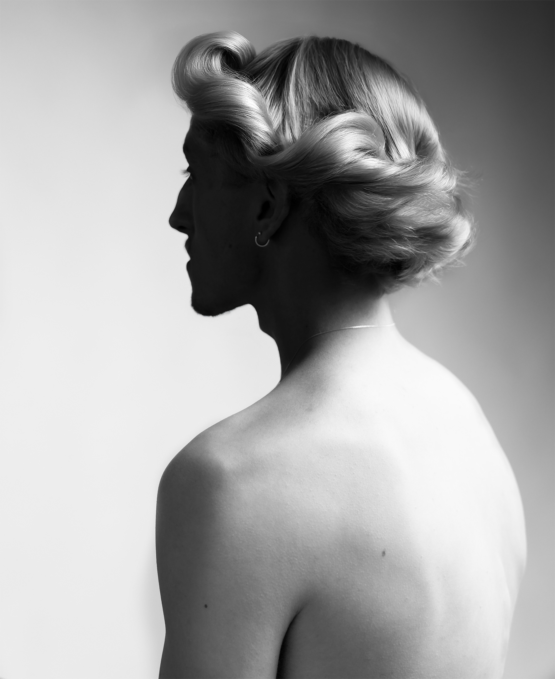 Fine art photography by Dai Scheffer, Dutch photographer, titled ‘Obscura’ A black-and-white photographic portrait of a young man with a shadow, exploring mood and presence. Limited luxury editions printed on Hahnemühle Baryta Pearl, available exclusively through Lindenbaum Gallery. Exhibited internationally and available for sale at select art fairs. The Netherlands.